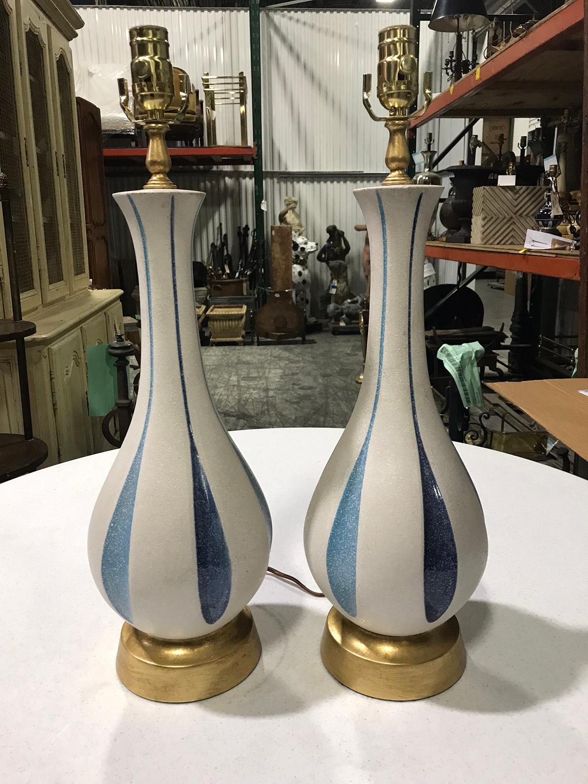 Pair of mid-20th century white and blue pottery lamps on custom gilt bases
New wiring.