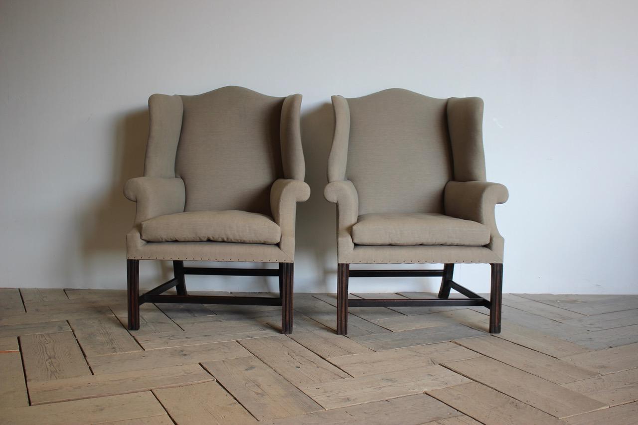 A handsome pair of George III style mahogany wing chairs with all the right shapes in all the right places. This generous and comfy pair of 'wings' have well proportioned 'H' stretchered and channel moulded show wood frames with a great 'kick' to