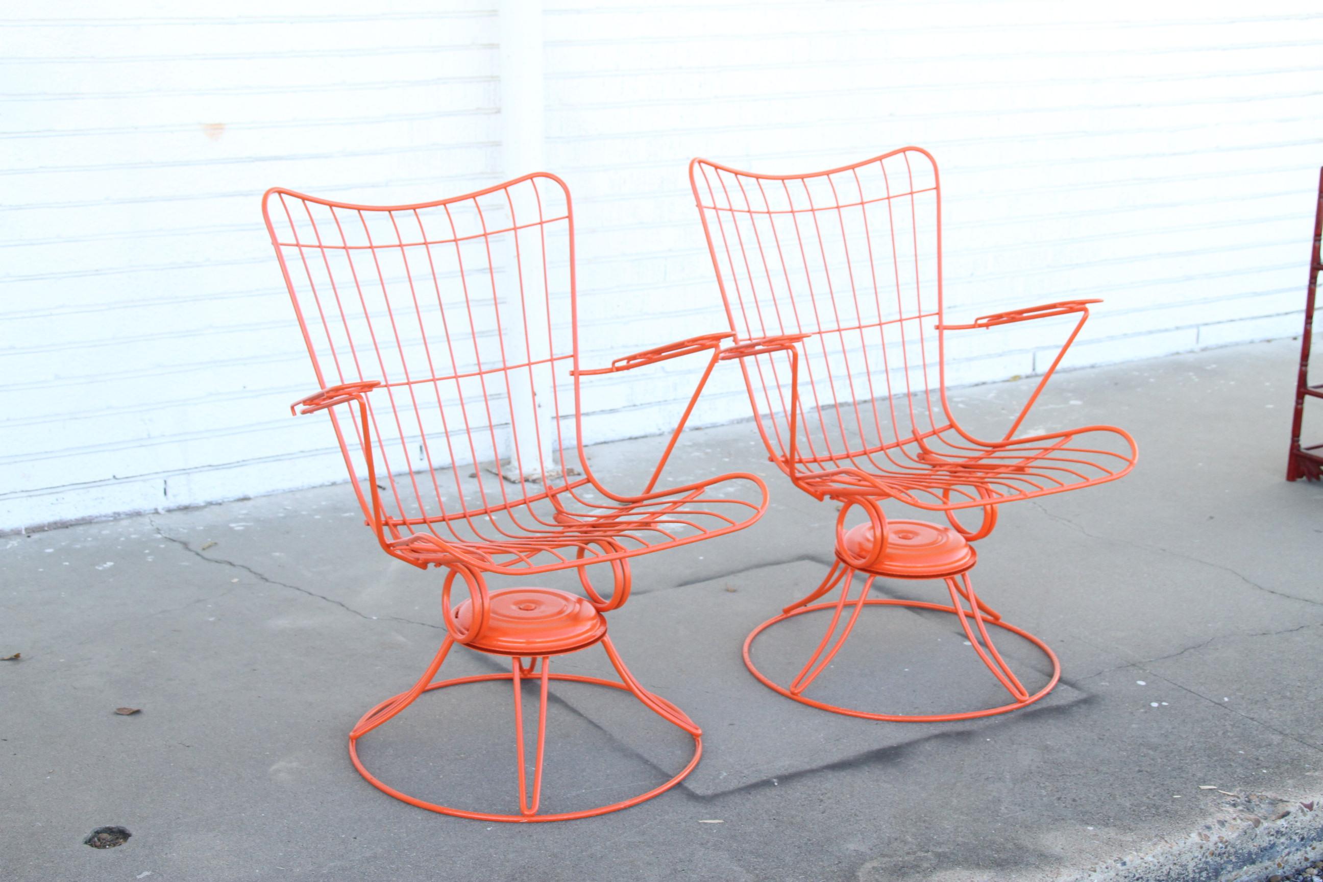 What a find. Offered is a pair of midcentury wrought iron swivel/rocker patio lounge chairs (model 36) made by Homecrest Bottemiller, circa 1968. These chairs swivel and rock, and have been repainted in an atomic orange. They're in good condition