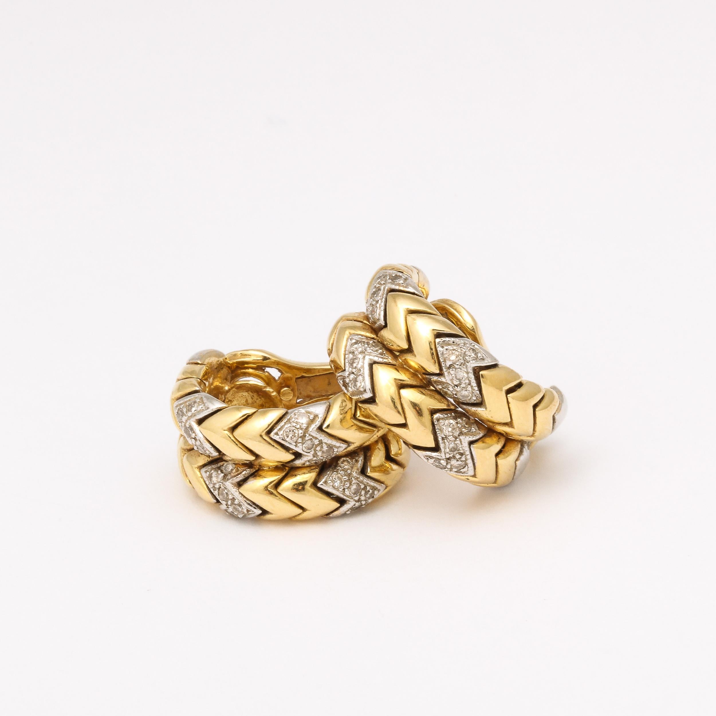 This sophisticated and elegant Pair of Earrings were crafted in the United States Circa 1970. Fashioned in repeating segments of 18 Carat Yellow and White Gold with 20 Round Cut Diamonds set into the white gold Tessellated Zig Zag motif, with a