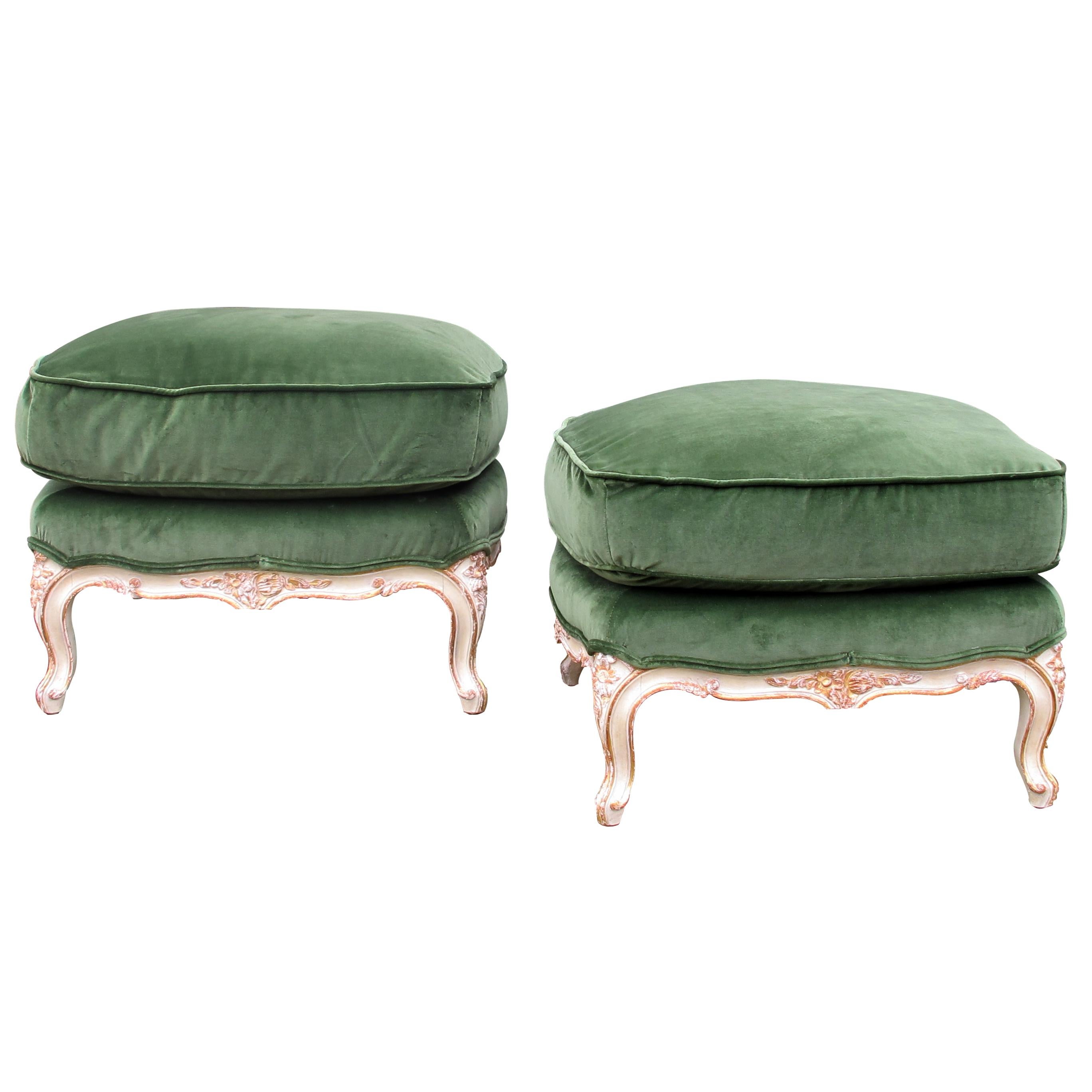 Pair of 1940s, mid century, French footstools or ottomans in Louis’ XVI style with floral carvings, painted and parcel gilt with loose cushions. The stools are newly upholstered in deep olive-green luscious fabric, the cushions have been given extra