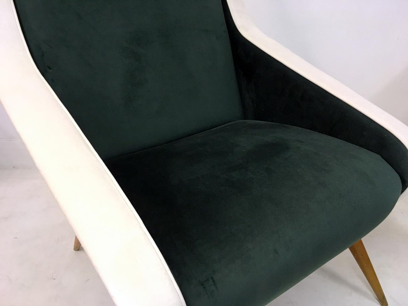 A pair of armchairs
New green and velvet upholstery
Wooden legs
Italian 1950s
Seat height 40cm.
  