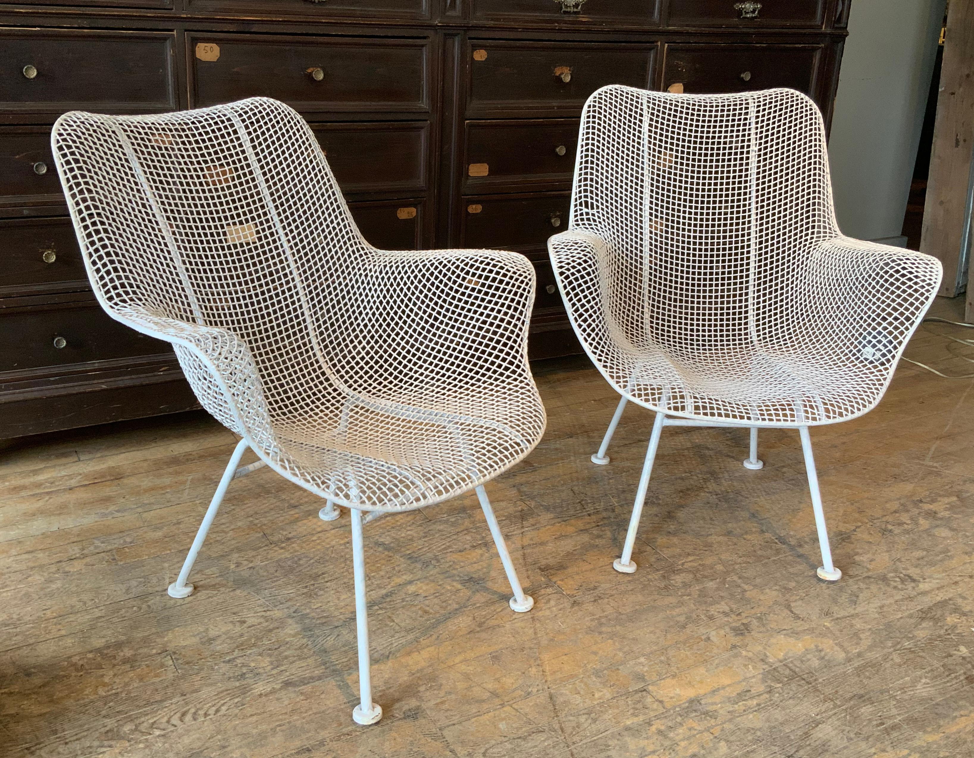 A pair of 1950s midcentury Woodard Sculptura high back lounge chairs, in their original white finish. Comfortable and stylish, beautiful examples of these Classic chairs. Sculptura was Russell Woodard's most iconic collection from the 1950s, with
