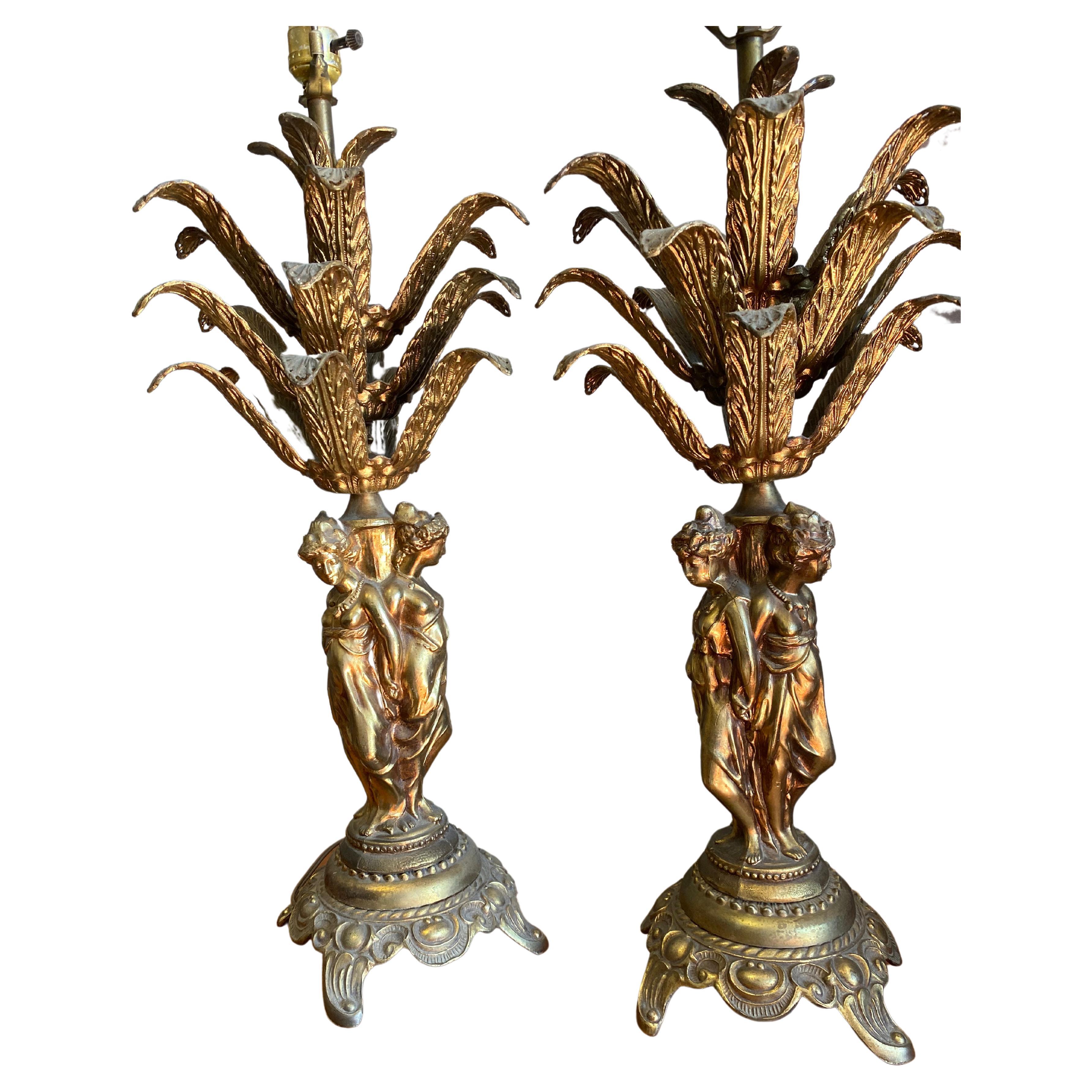 Beautiful vintage brass lamps. The shades for the lamps are simply gorgeous. The design of the lamps with the overhanging palm leaves are breath taking. Such statement pieces for your home. Hanging crystals also included as photographed. There are