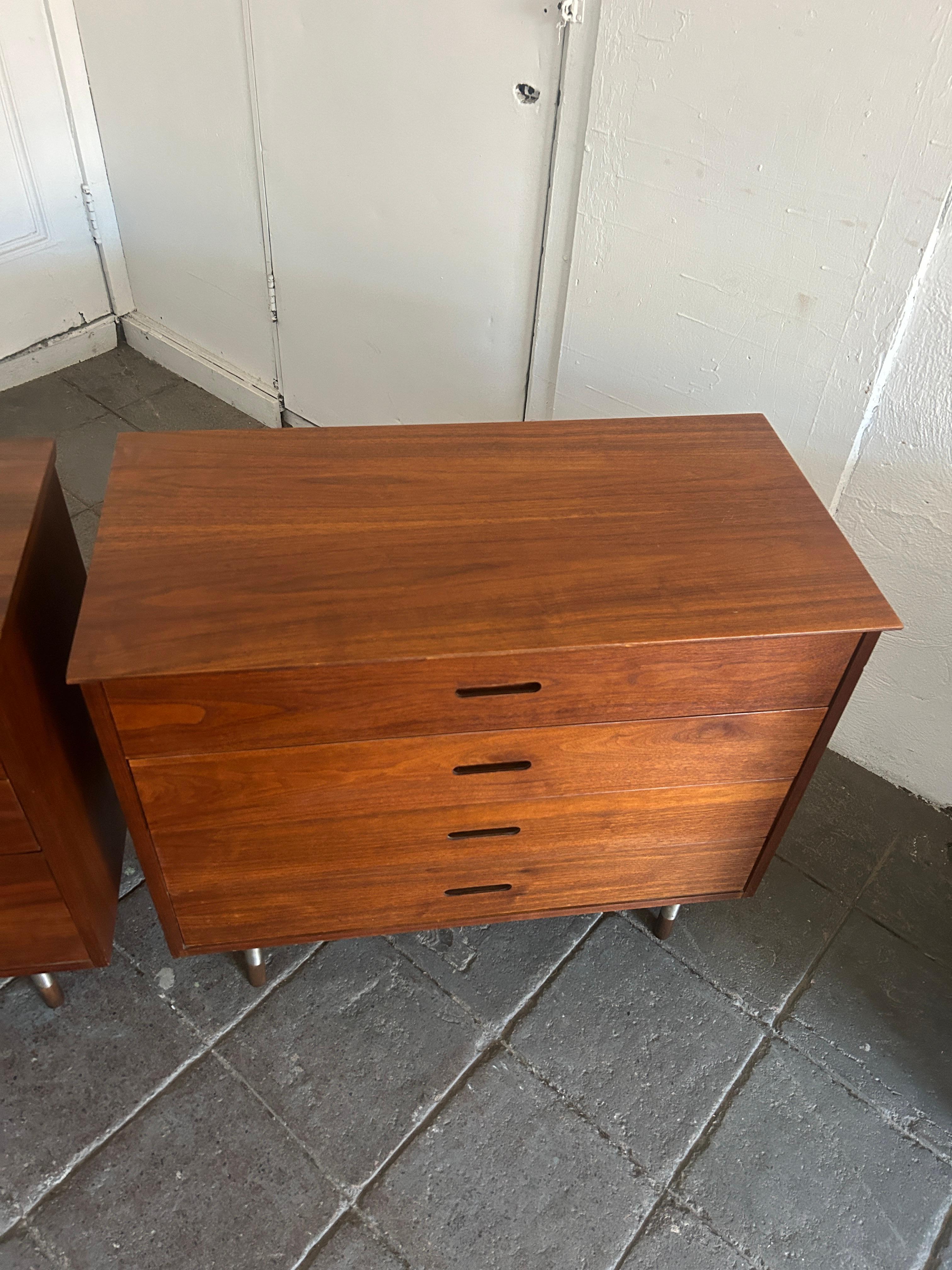 Pair of mid century 4 drawer walnut dressers by founders. Great pair of walnut dressers inset carved handles. Each dresser sits on 4 round steel and walnut dowel legs. Great matching pair. Made in USA by founders. Ready for use. Located in Brooklyn