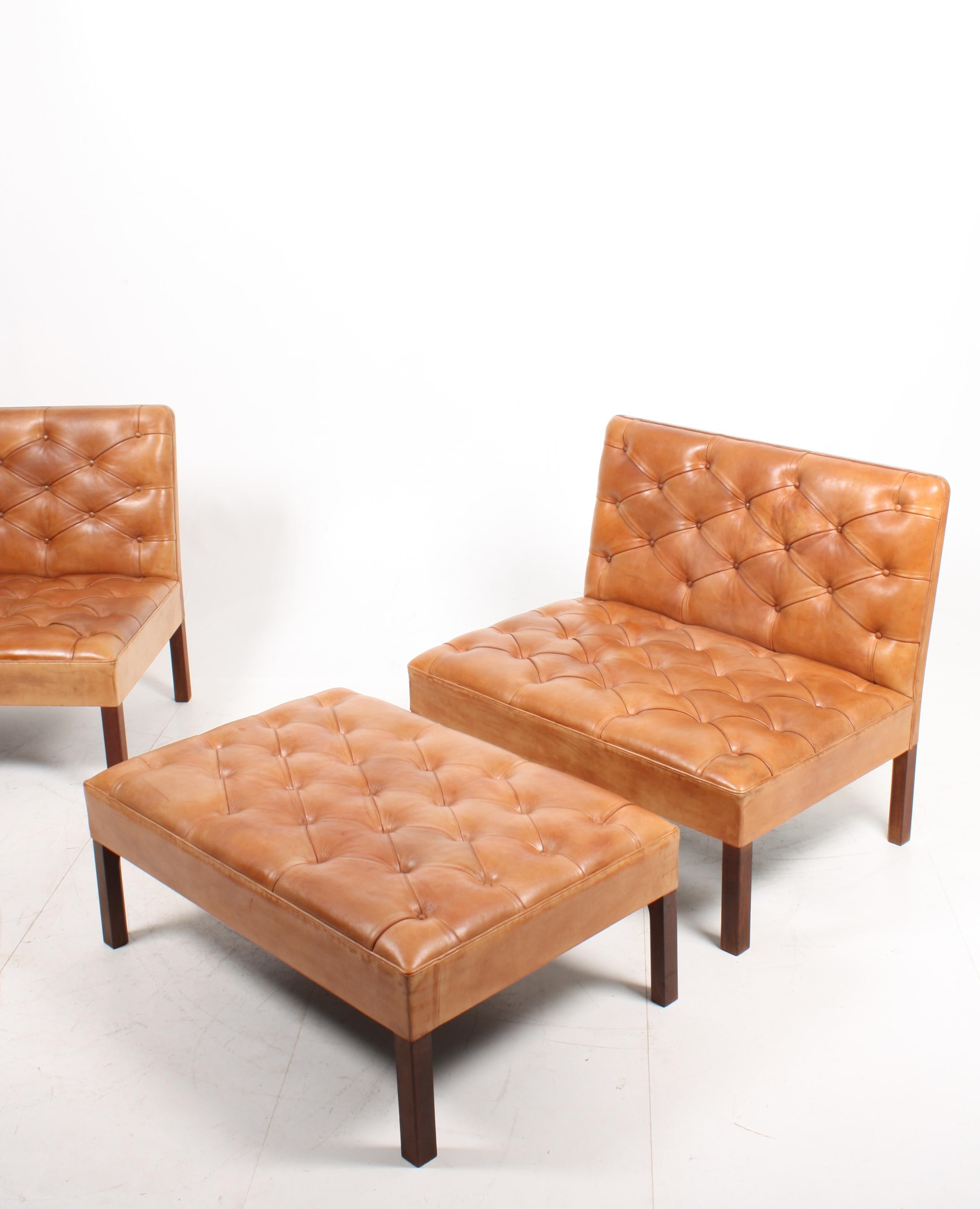 Pair of addition sofas with a matching bench in patinated leather Designed by M.A.A Kaare Klint for Rud. Rasmussen in the late 1930s. Great original condition. Made in Denmark.