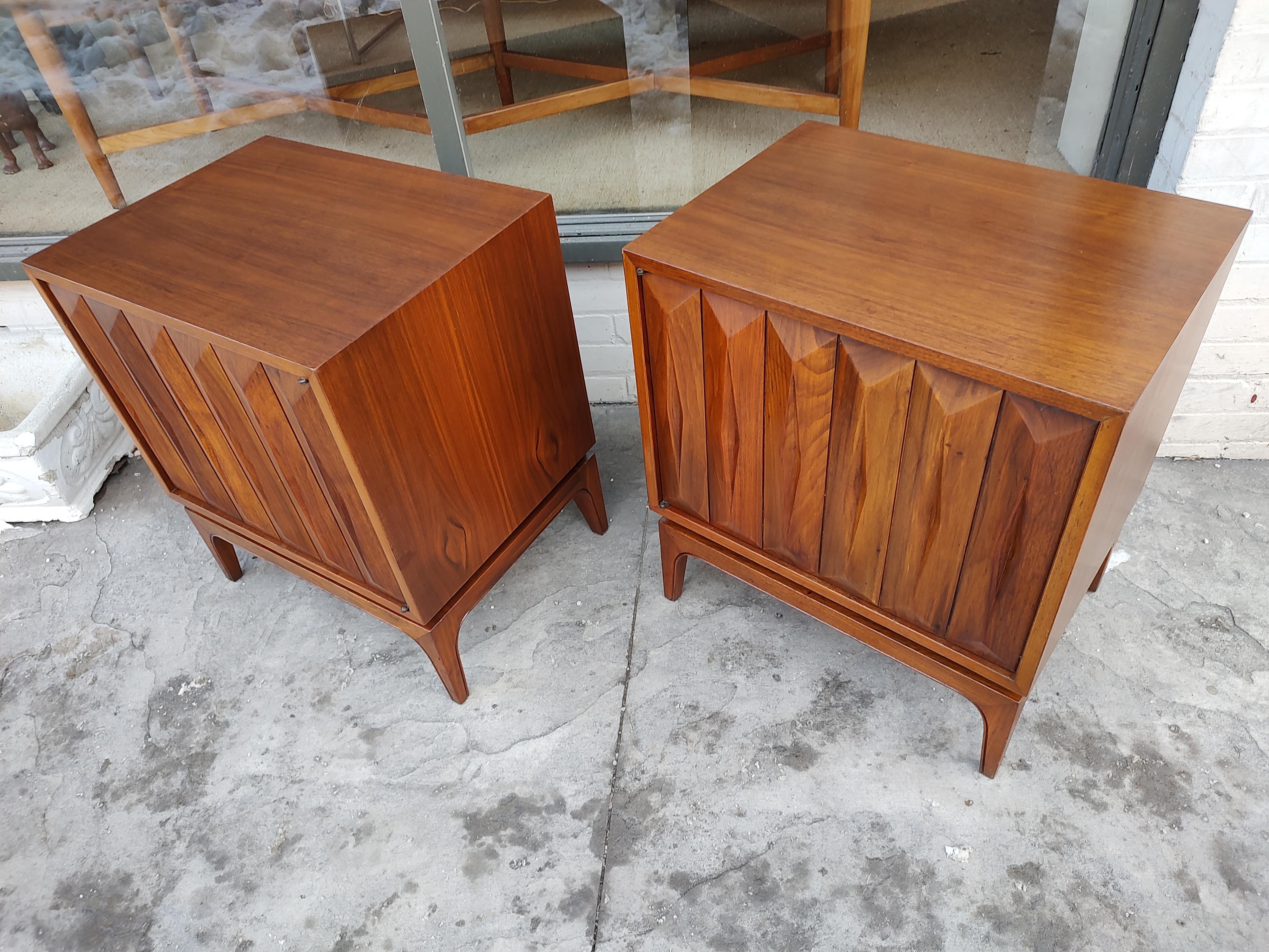 Fabulous pair of walnut diamond faceted nightstands by Albert Parvin. Push button door opens to reveal one Shelf in both cabinets. They were recently refinished and look great. Walnut is exceptional and are tight and structurally sound.