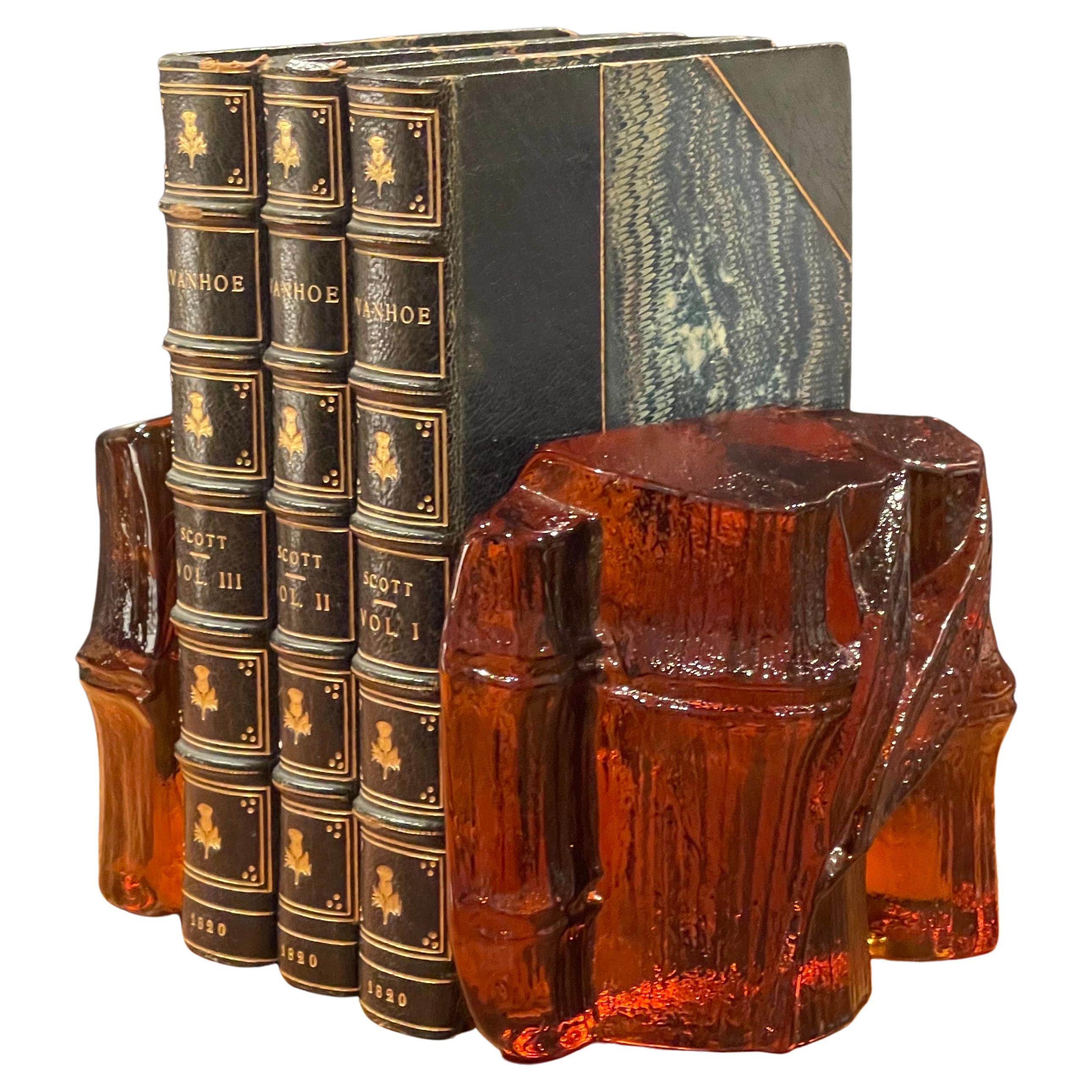 Midcentury pair of amber colored glass bamboo shaft bookends by Blenko, circa 1970s. The bookends are heavy and solid with a smooth back and a textural finish on the front. They are in very good vintage condition with no chips or cracks and Measure