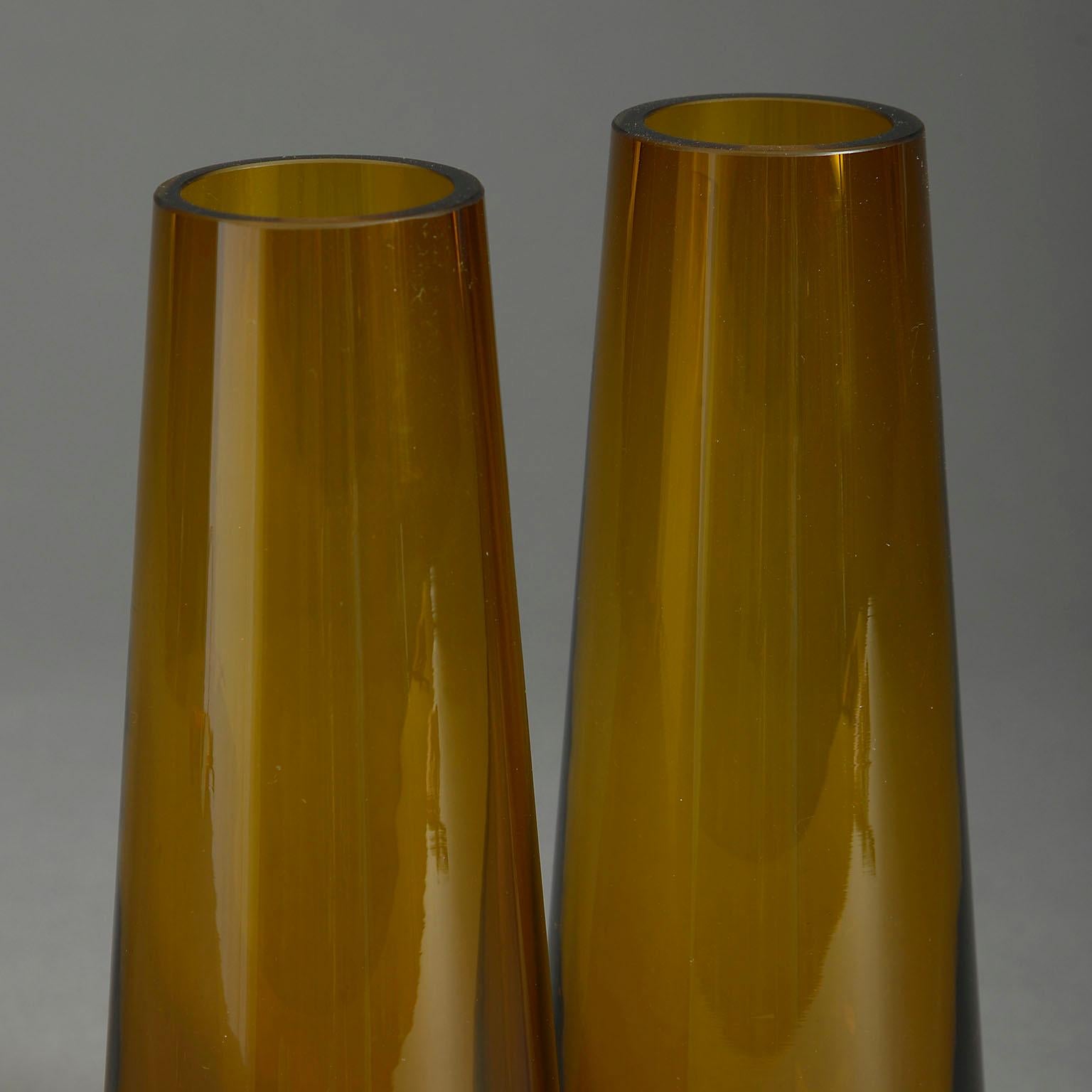 A pair of mid-century amber glass vases of rich colour and tapering form.