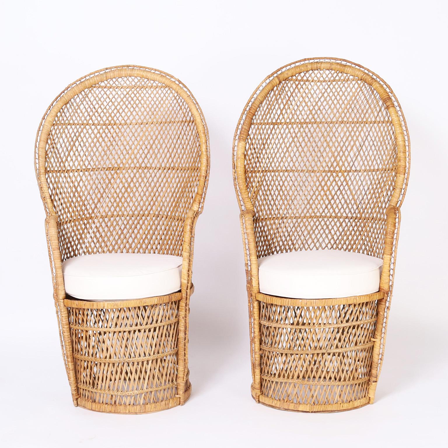 Tropical pair of vintage Anglo Indian peacock chairs crafted in wicker and rattan with an unusual smaller scale and barrel back design.
