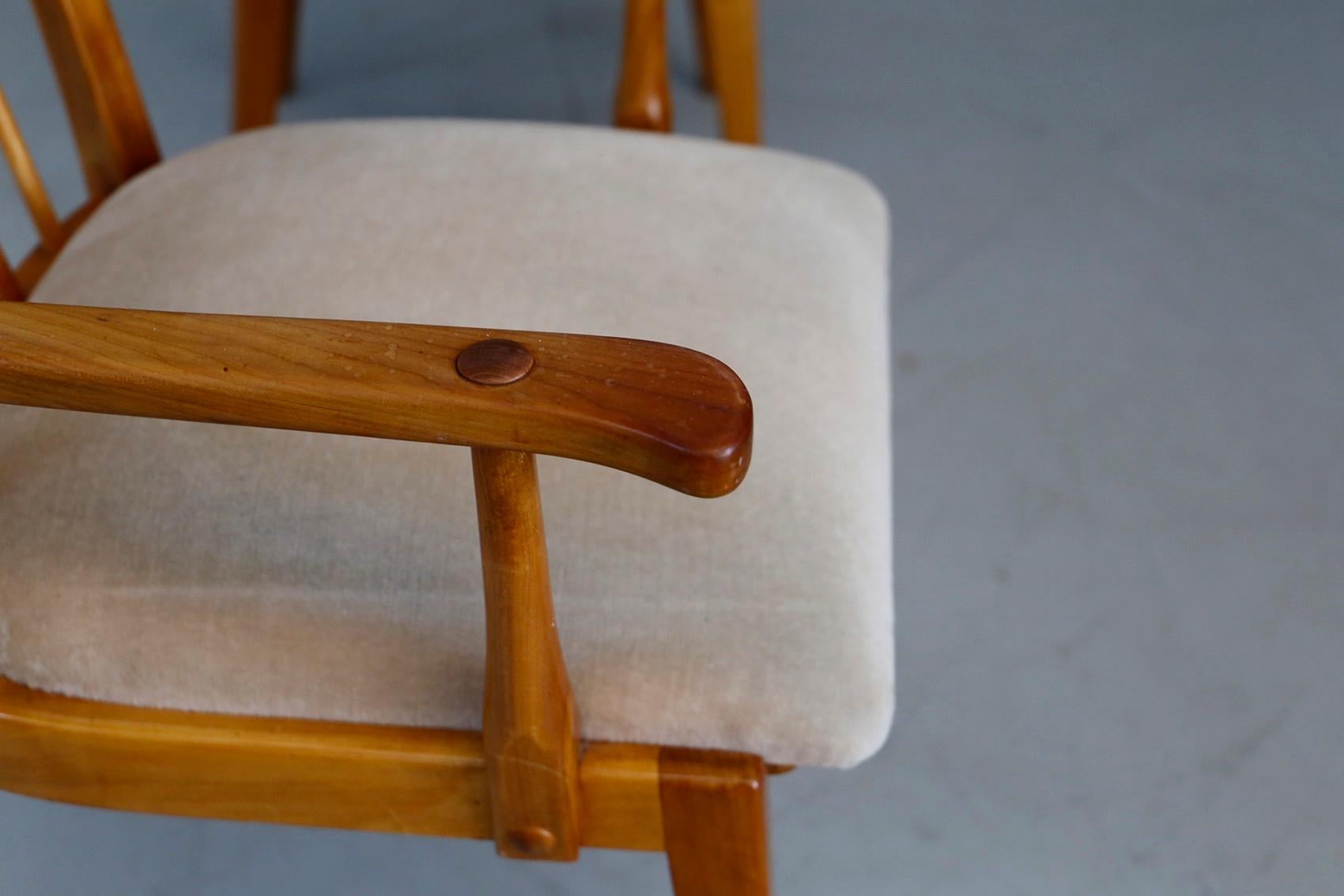 Set of two Swedish designed chairs made of cherrywood. From 1950s. Note the interlocking realization. The set was made with great skill of wood craftsmen. The structure of the backrest is made of wooden slats perfectly interlocked by a wooden stick