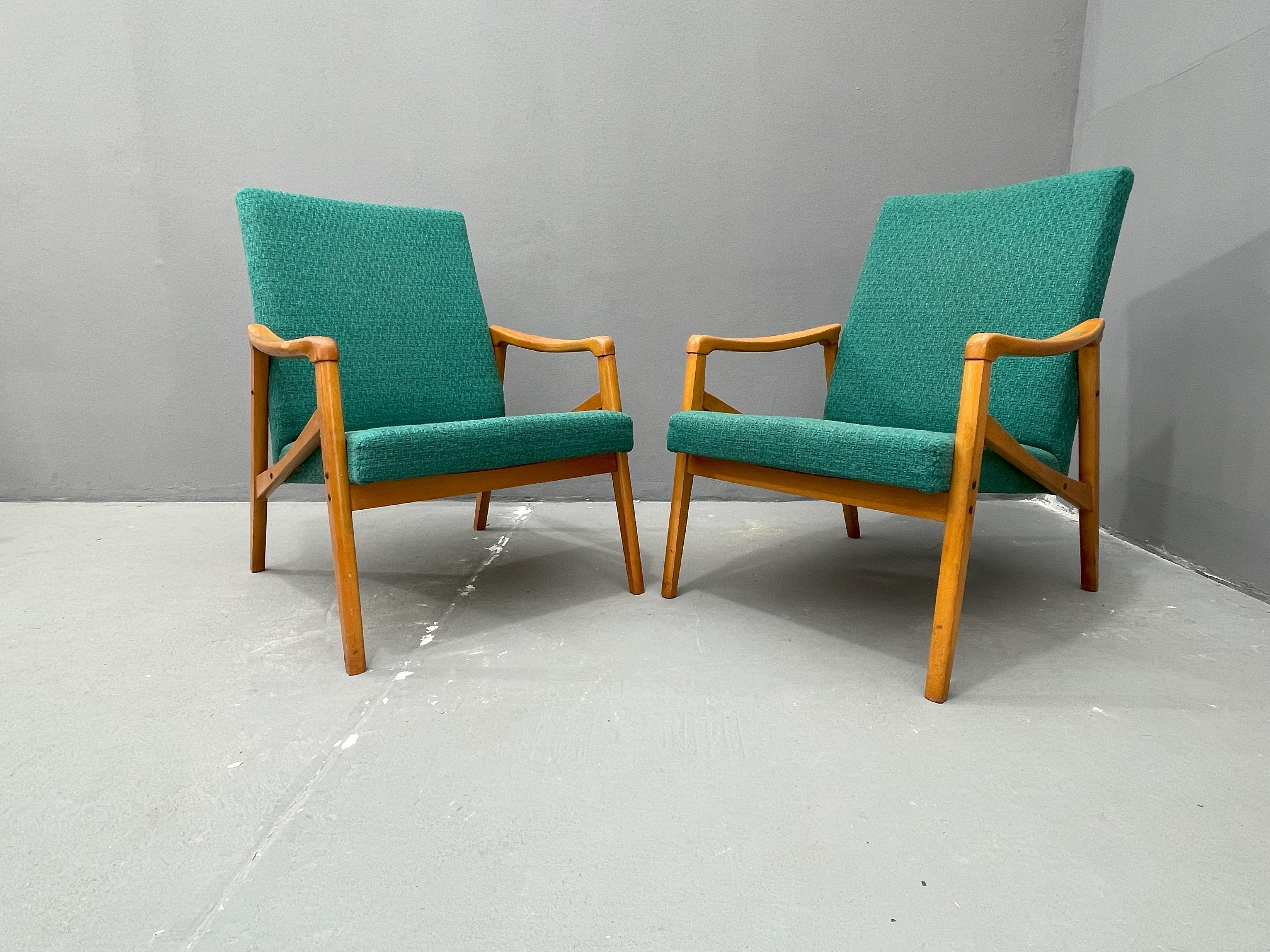 Offriamo una coppia di poltrone retrò disegnate da Jiří Jiroutek per Interior Praha negli anni '60. È stato realizzato nell'ex Cecoslovacchia. Presenta una solida struttura in legno e un comodo rivestimento in tessuto verde. Le sedie hanno schienali