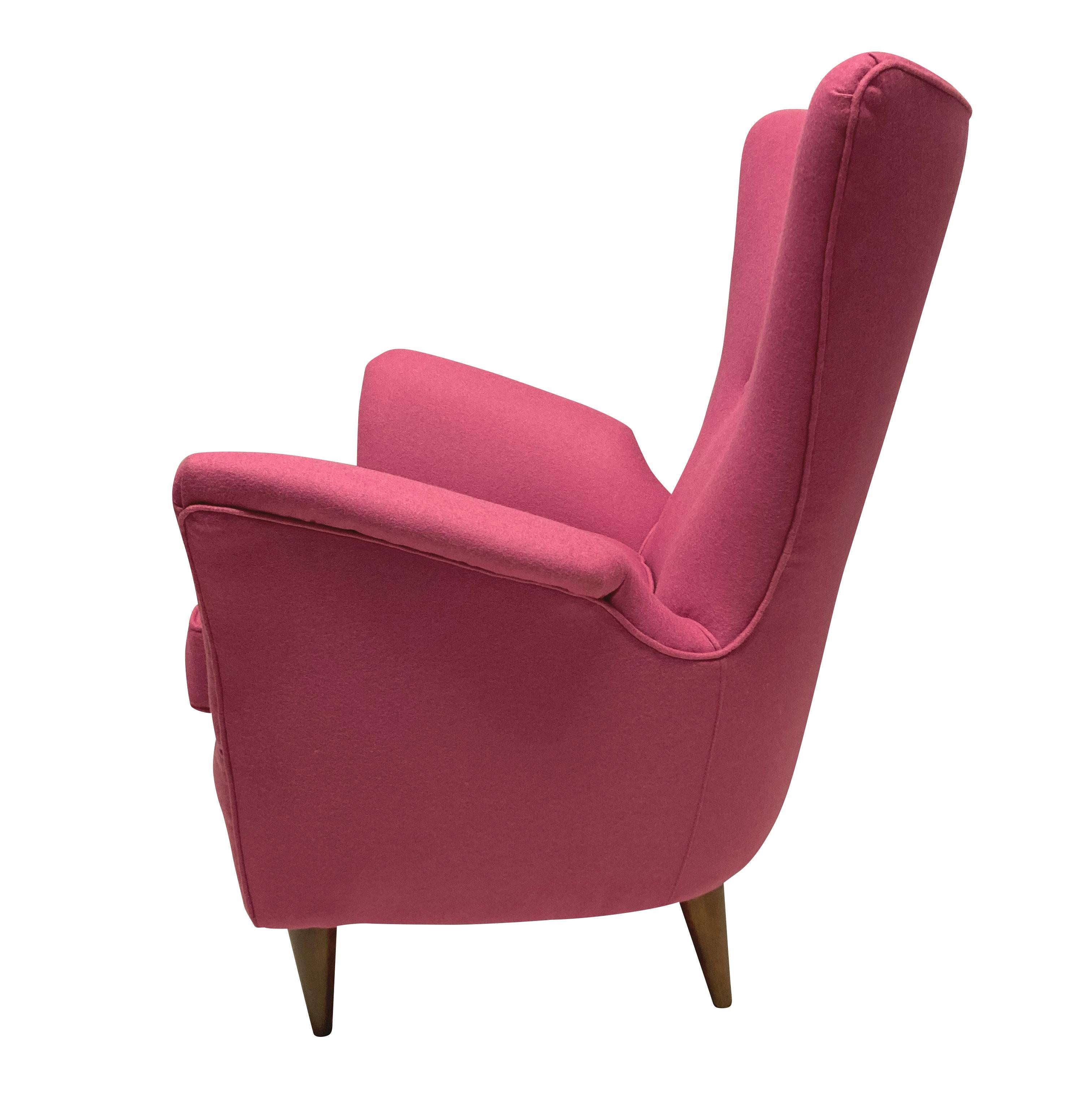 A pair of stylish Italian armchairs by Melchiore Bega. With French polished tapering walnut legs and newly upholstered in pink wool.