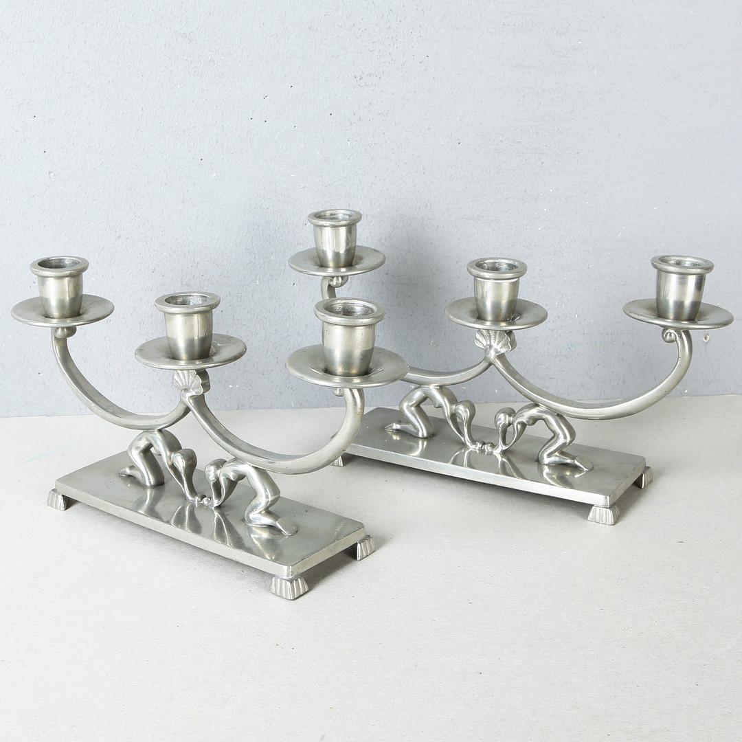 Pair of Swedish Pewter candlestick holders with female figures, made in 1933.
Nyköping's Ciselörsverkstad.