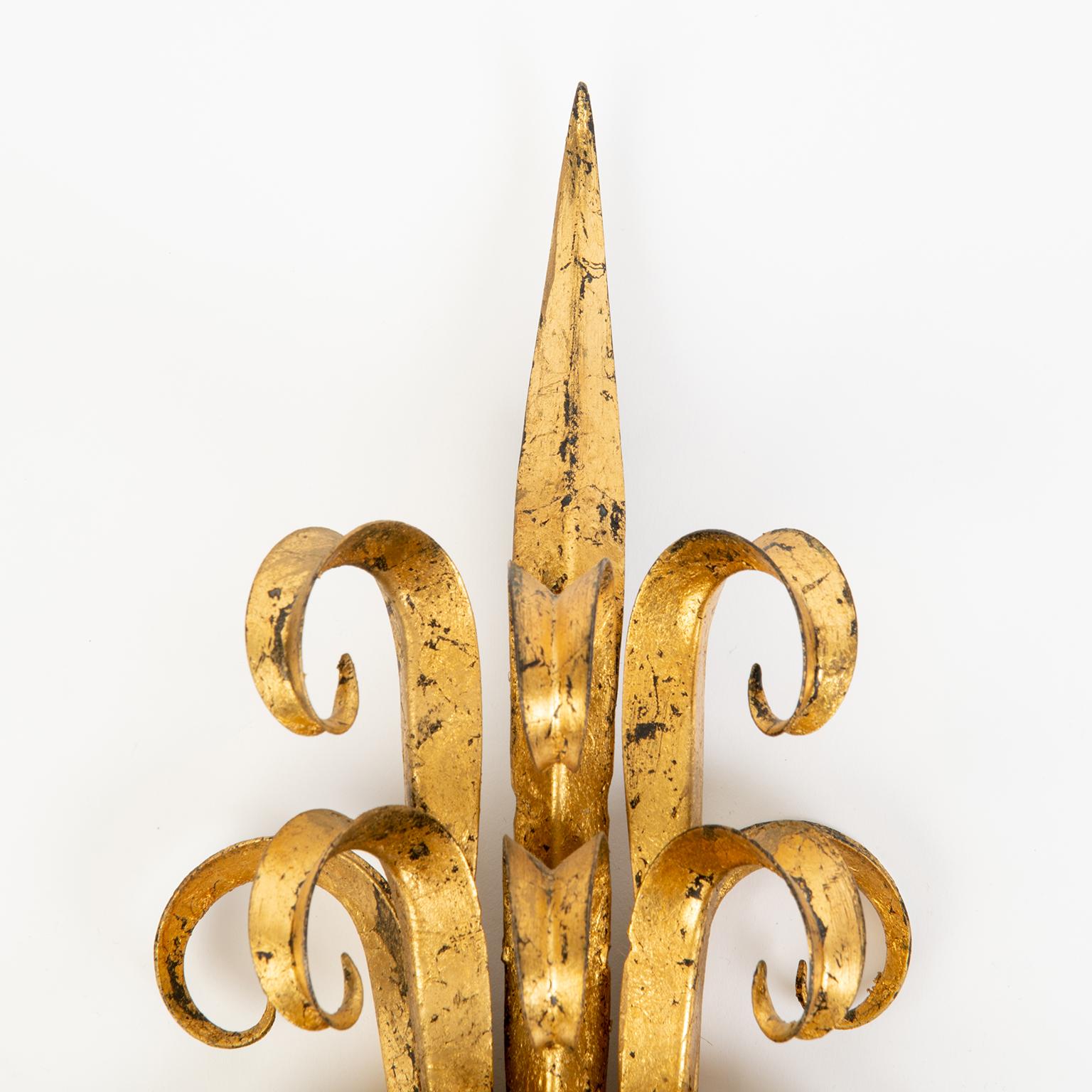 These beautiful scrolled gilt metal sconces are in the Deco style and are made in Florence, Italy in the 1960s.
They are designed for candles but may be electrified.