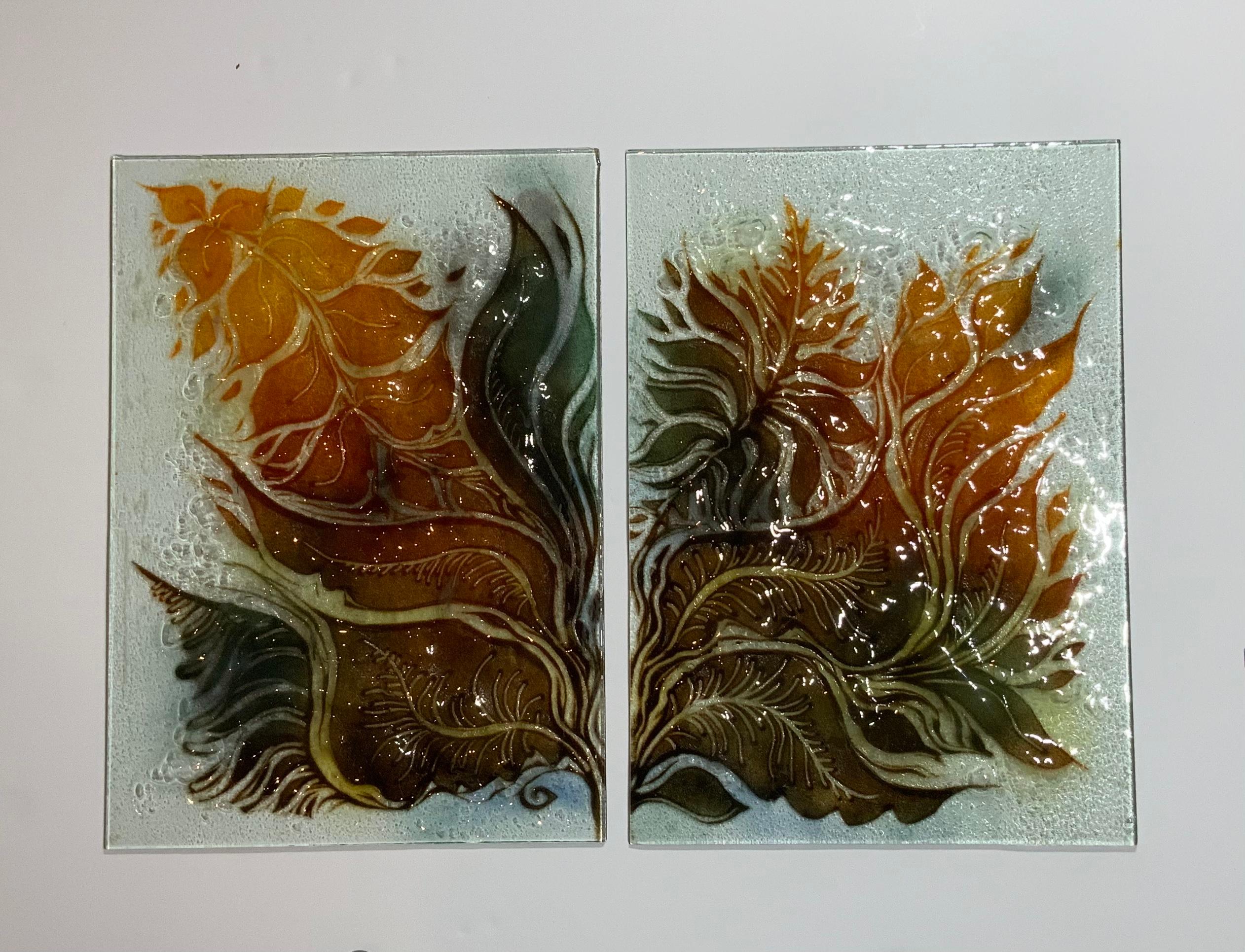 Beautiful pair of Israeli art glass plates made of two hand painted sheet of glass put together and bake in the kiln in high temperature , bond together with dents and texture, to achieve exceptional mix of color variation of vines and floral motifs
