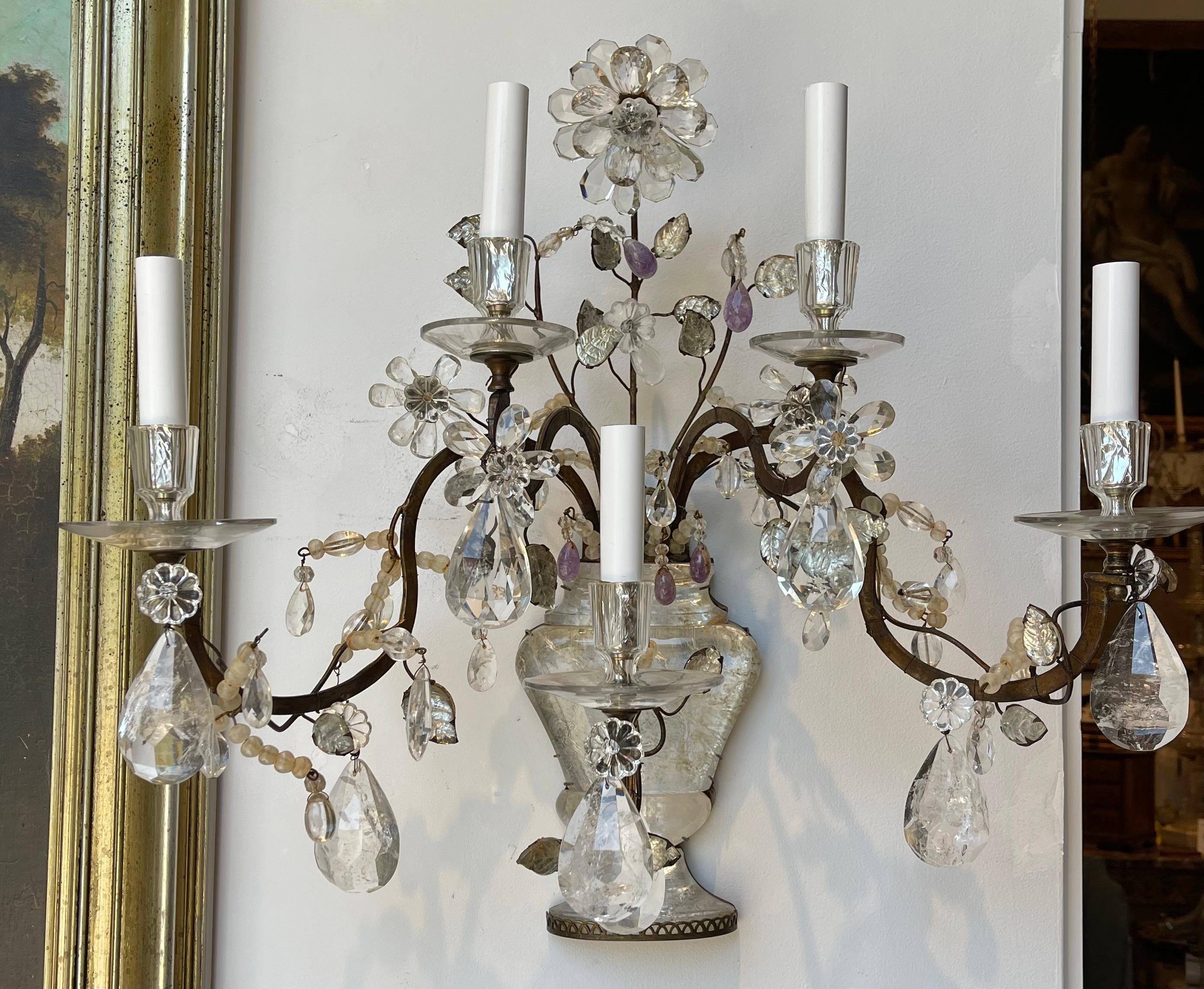 Pair of Significant Maison Bagues Rock Crystal and Iron Wall Sconces.  Hand cut rock crystal pendents and flowers.  Rock Crystal Urns issuing flower branches.  Wrought Iron Arms with natural patina and early silver remnants.  

Great 1940's Bagues,