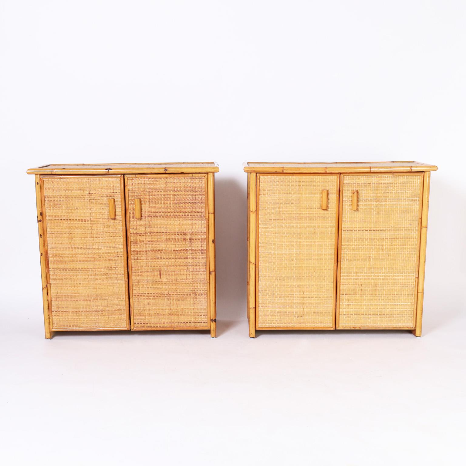 Standout pair of Italian cabinets crafted with bamboo frames and grasscloth panels all around in a sleek modern form with two doors and plenty of storage inside.