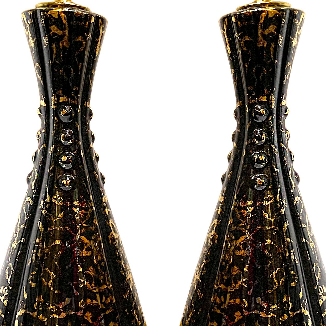 A pair of Italian circa 1950's black porcelain lamps with gold decoration.

Measurements:
Height of body: 15.5