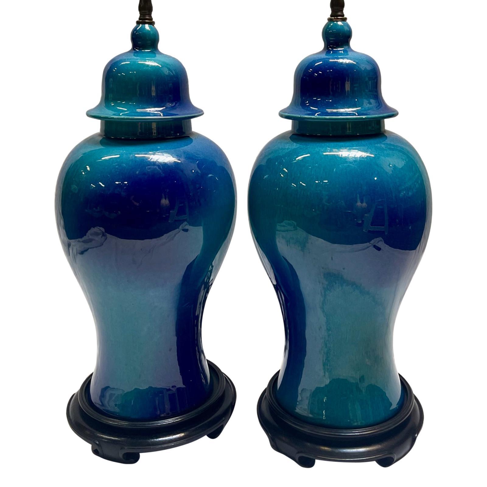 A pair of French circa 1950's glazed porcelain table lamps in blue tones.

Measurements:
Height of body: 19