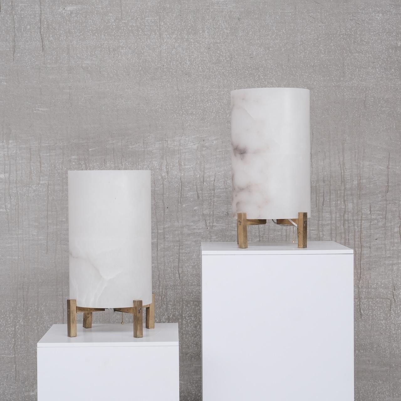 A pair of alabaster and brass table lamps. 

France, c1980s. 

Tall alabaster shades sit over brass x frames. 

Since re-wired and PAT tested. 

Good condition, 

Location: Belgium Gallery. 

Dimensions: 50 height x 29 diameter in cm.