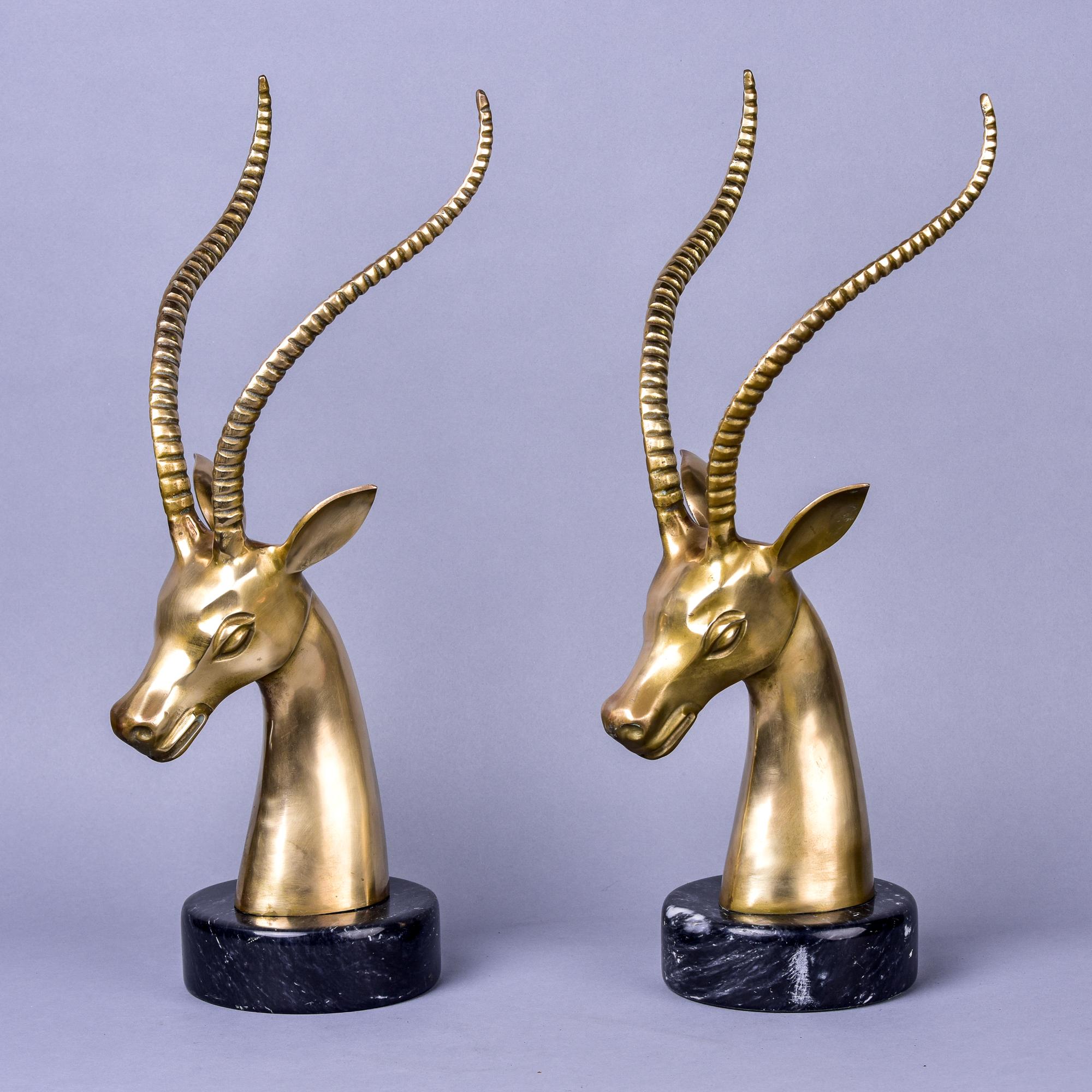 Circa 1960s pair of solid brass gazelles mounted on black marble bases. Classic mid century look. Very good vintage condition with some scattered patina/wear but no flaws found. Unknown maker. Sold and priced as a pair.