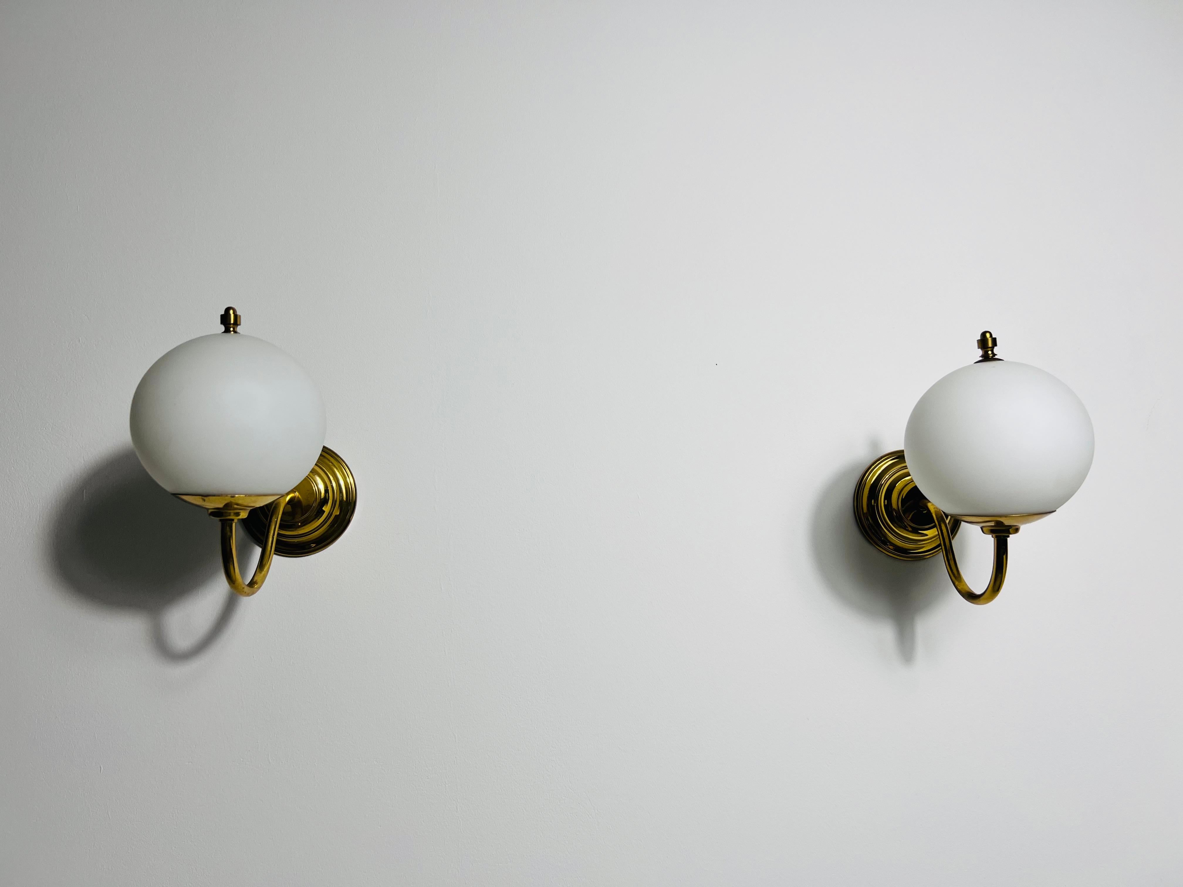 These exquisite fixtures beautifully blend Midcentury Modern aesthetics with antique design elements, creating a harmonious balance that elevates any room. Featuring a sleek brass frame that exudes sophistication, each lamp is adorned with luminous