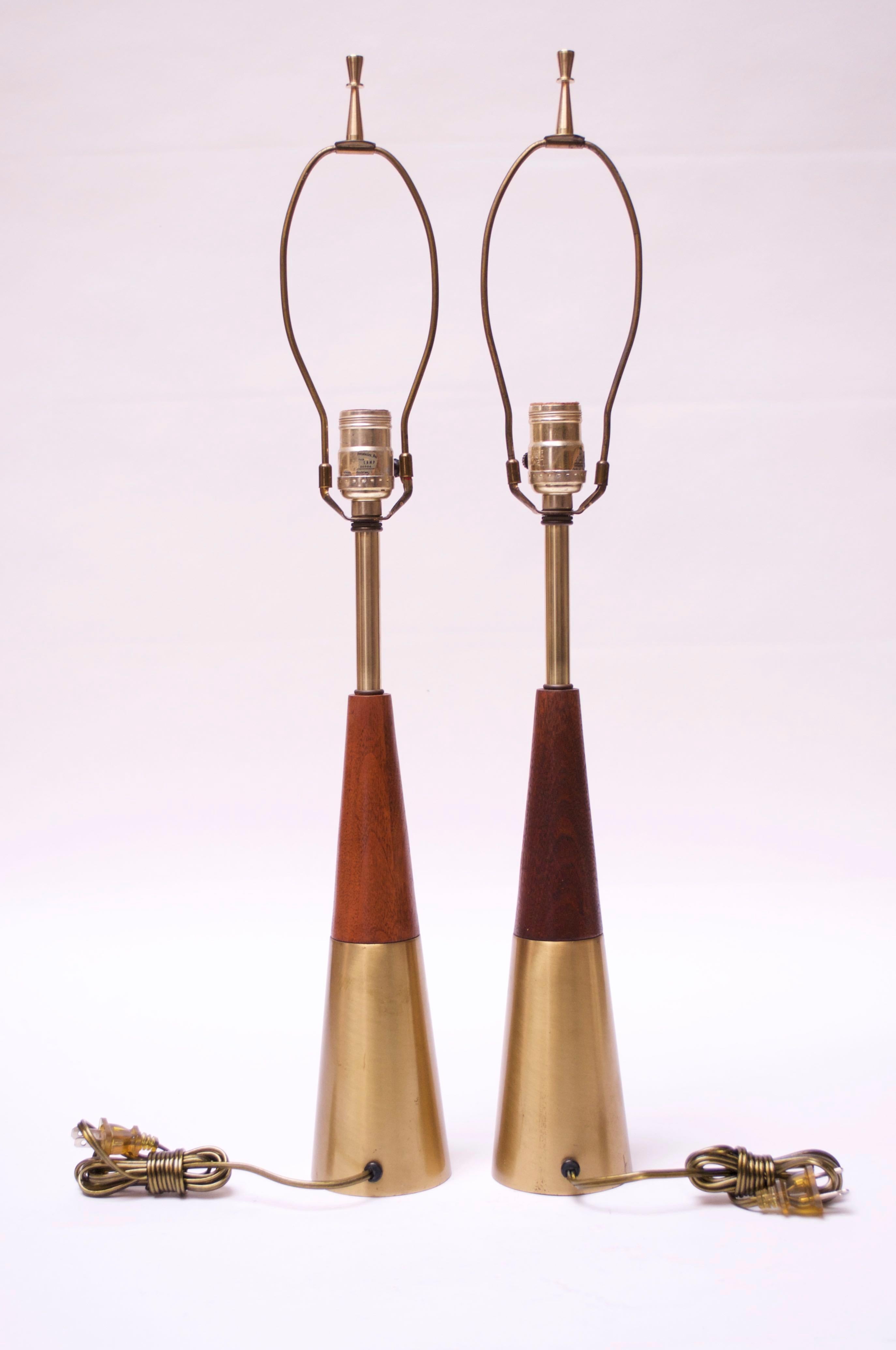 Conical lamps in Swedish brass and solid walnut (Model D390) designed by Tony Paul for Westwood circa 1958.
Include the original finials, scarcely seen with the lamps.
Brass shows spots of wear / tarnish in places, as shown. The walnut has been