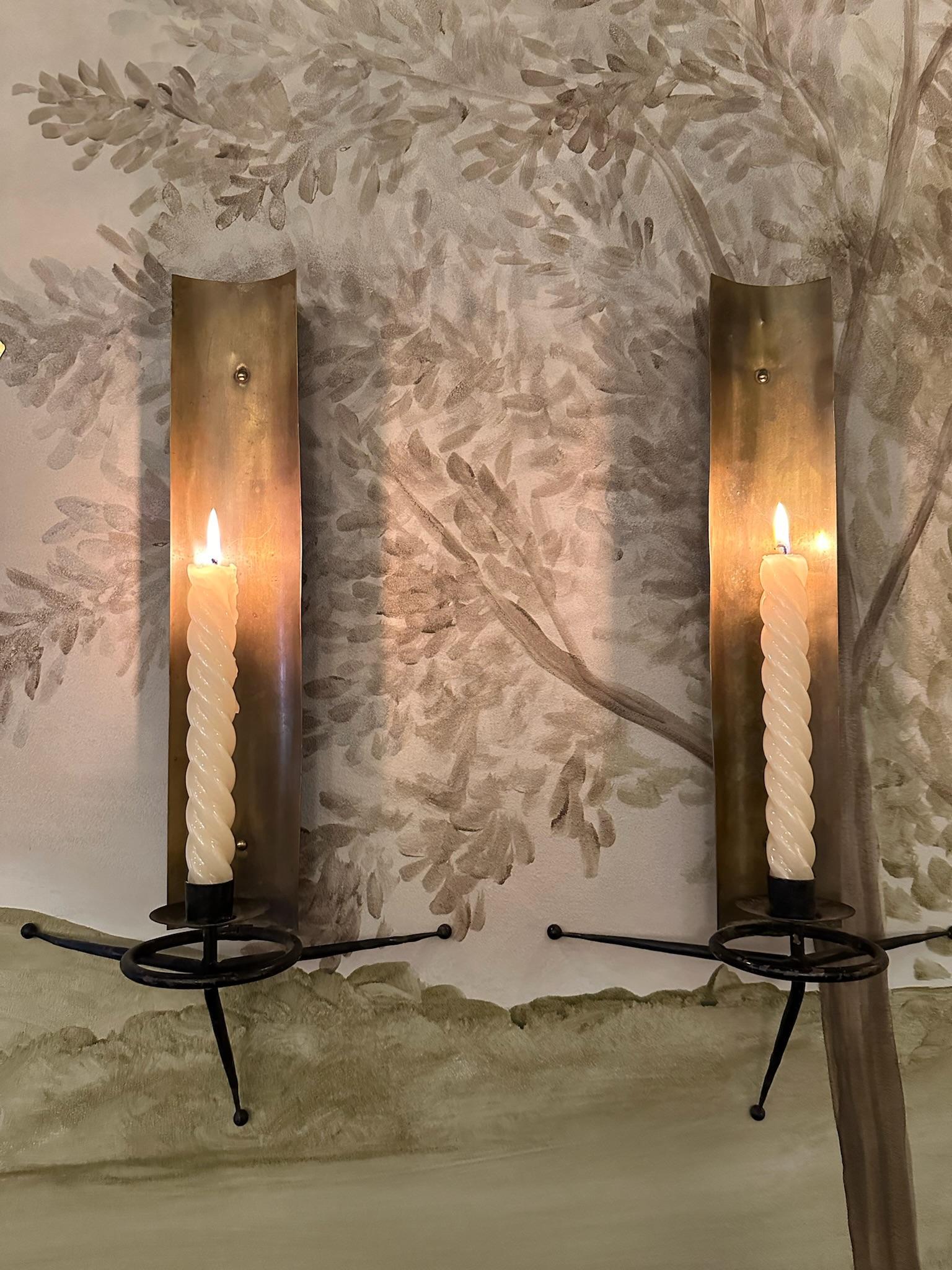 Pair of brass and black metal candle sconces by Tony Paul. Circa 1950s.