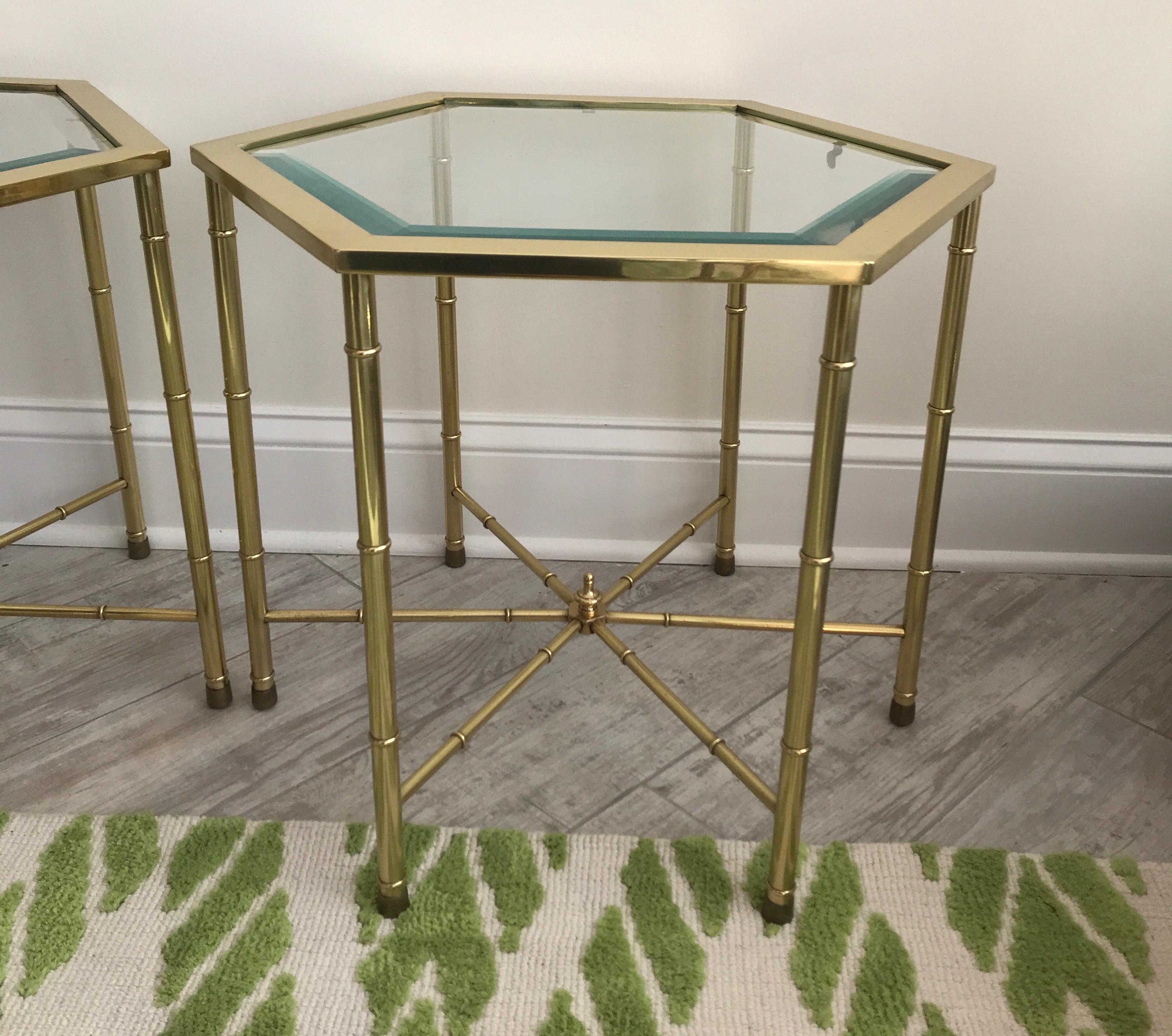 Pair of brass hexagon shaped drinks tables with glass tops.