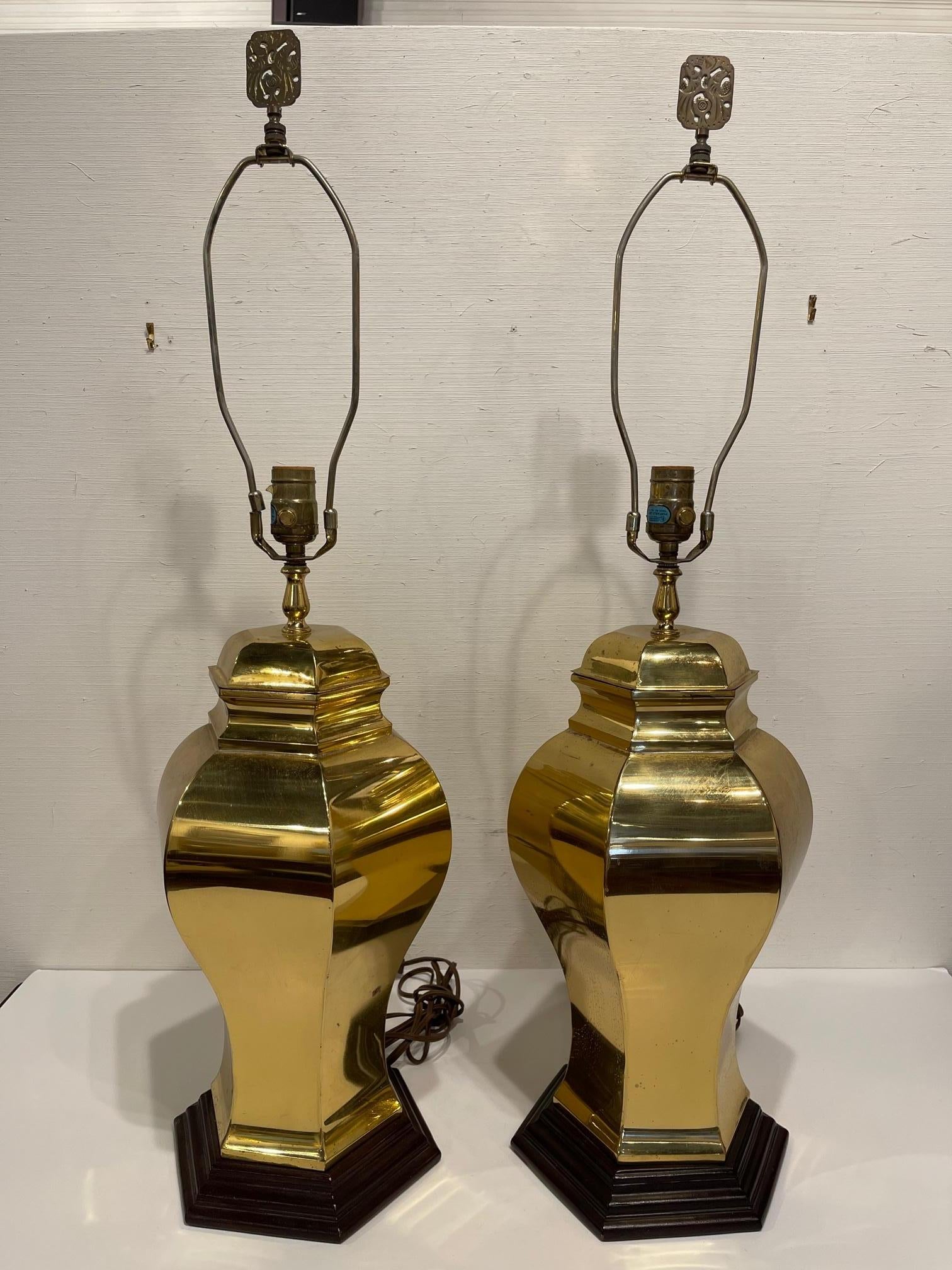 Pair of mid-century brass lamps on wood bases, 20th century.