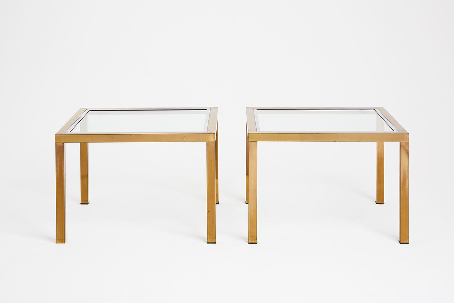 A pair of large brass and chrome glass topped square side tables.
France, circa 1970.