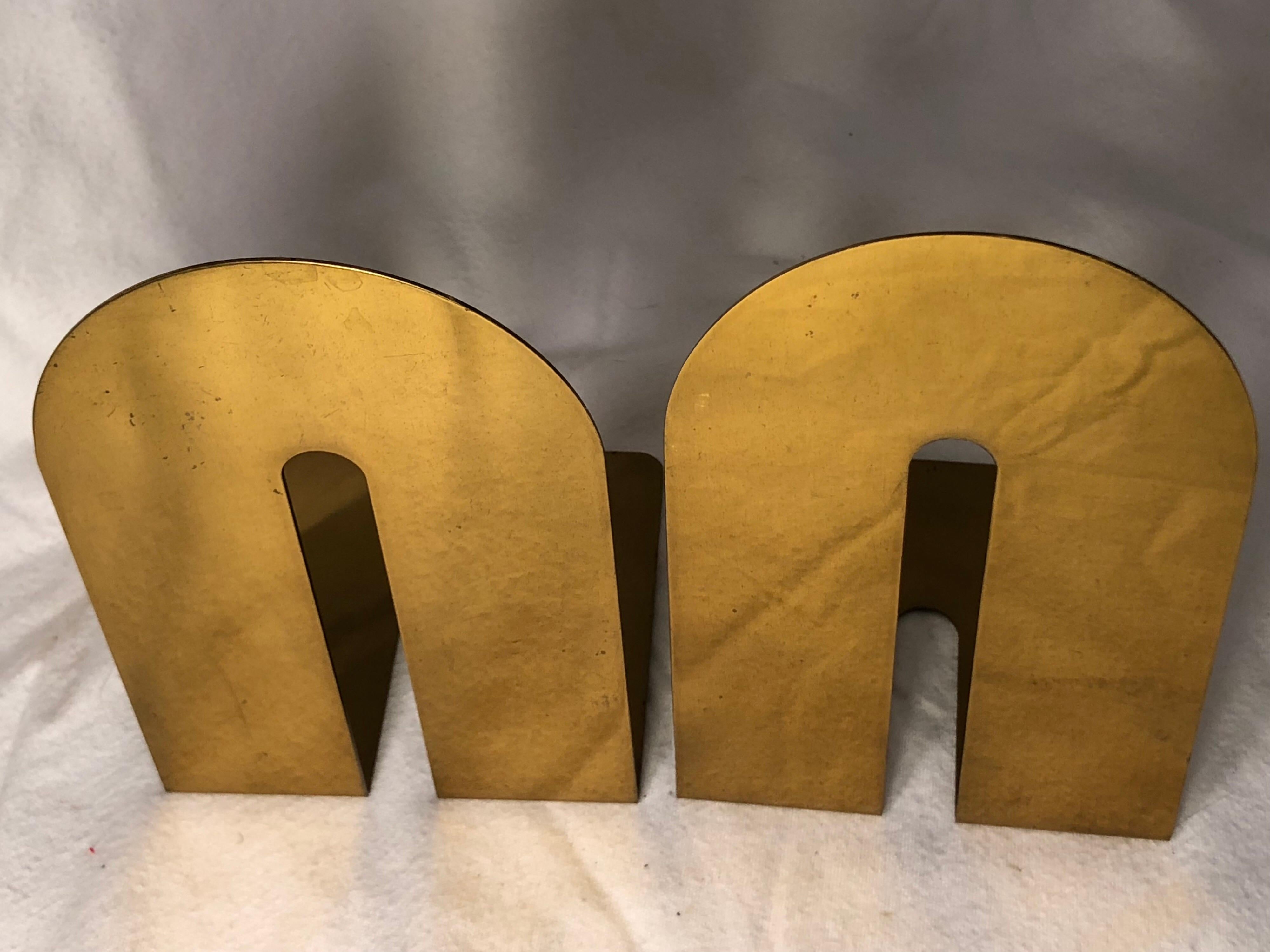 Pair of midcentury brass Walter Von Nessen style bookends. Although Art Deco in design they are from the MOD 1970s period. Perfect accessory for that mod, deco or Minimalist look. Each one measures 4