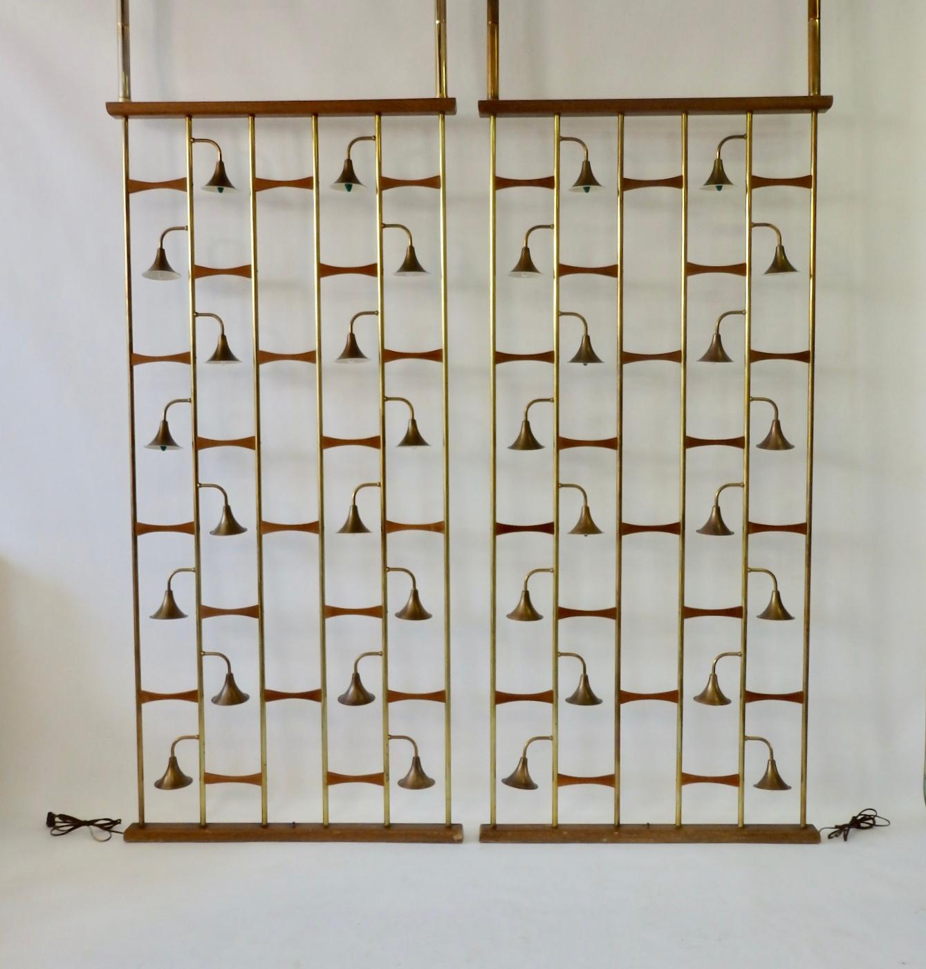Pair of brass rod with walnut spacer room dividers. Each has 16 lights. Pieces are designed to compression fit between floor and ceiling with spring loaded shafts at top.
