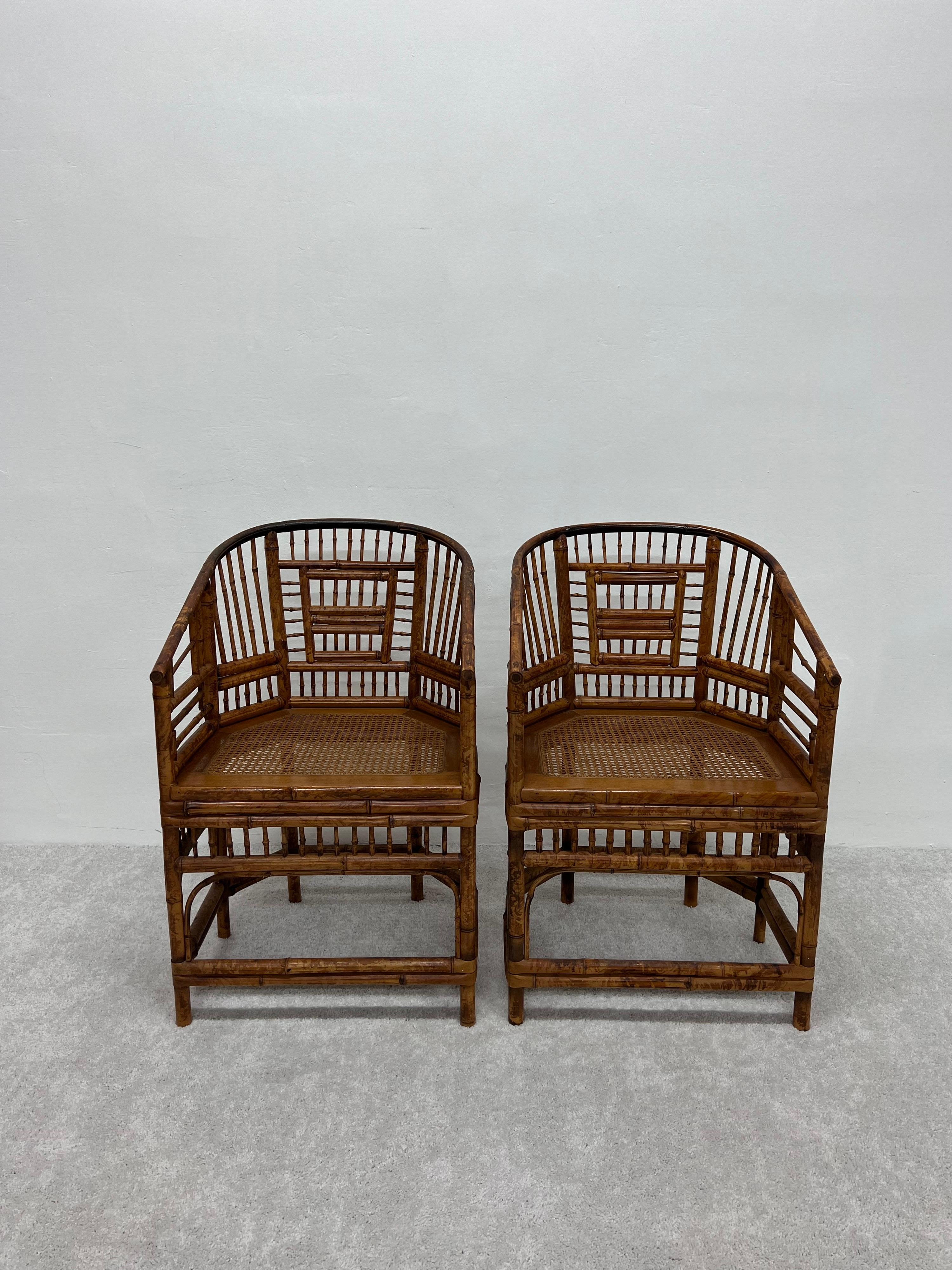 Pair of mid-century British Colonial dining or side chairs with tortoise style finish bamboo frames and rattan cane seats by Brighton Pavillion, 1970s.