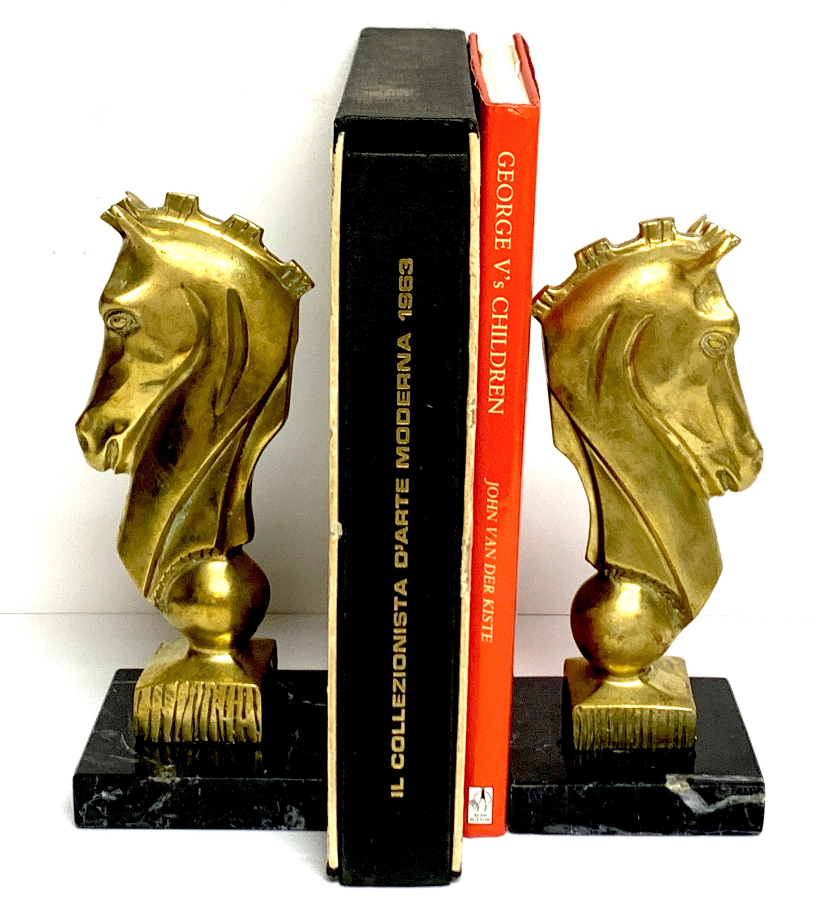 Pair of midcentury bronze and marble horse Motif bookends, Each one with stylized horse head, 8-inches high raised on a 3.5-inch square marble bases.
The books in the listing are for display only and are not included.
