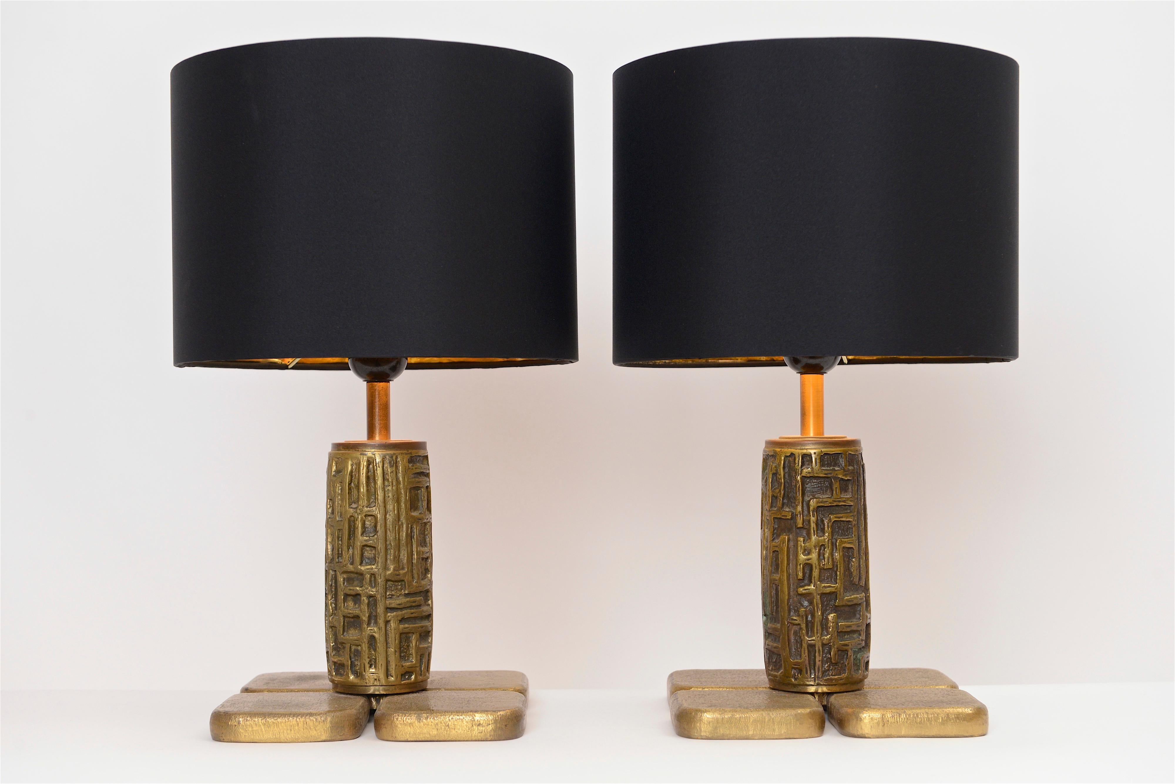 A beautiful pair of Brutalist bronze tables lamps by Luciano Frigerio, circa 1960. The lamps central structure has a wonderful abstract design whilst the lamps base is made of four bronze squares. These high quality lamps have a great patina and