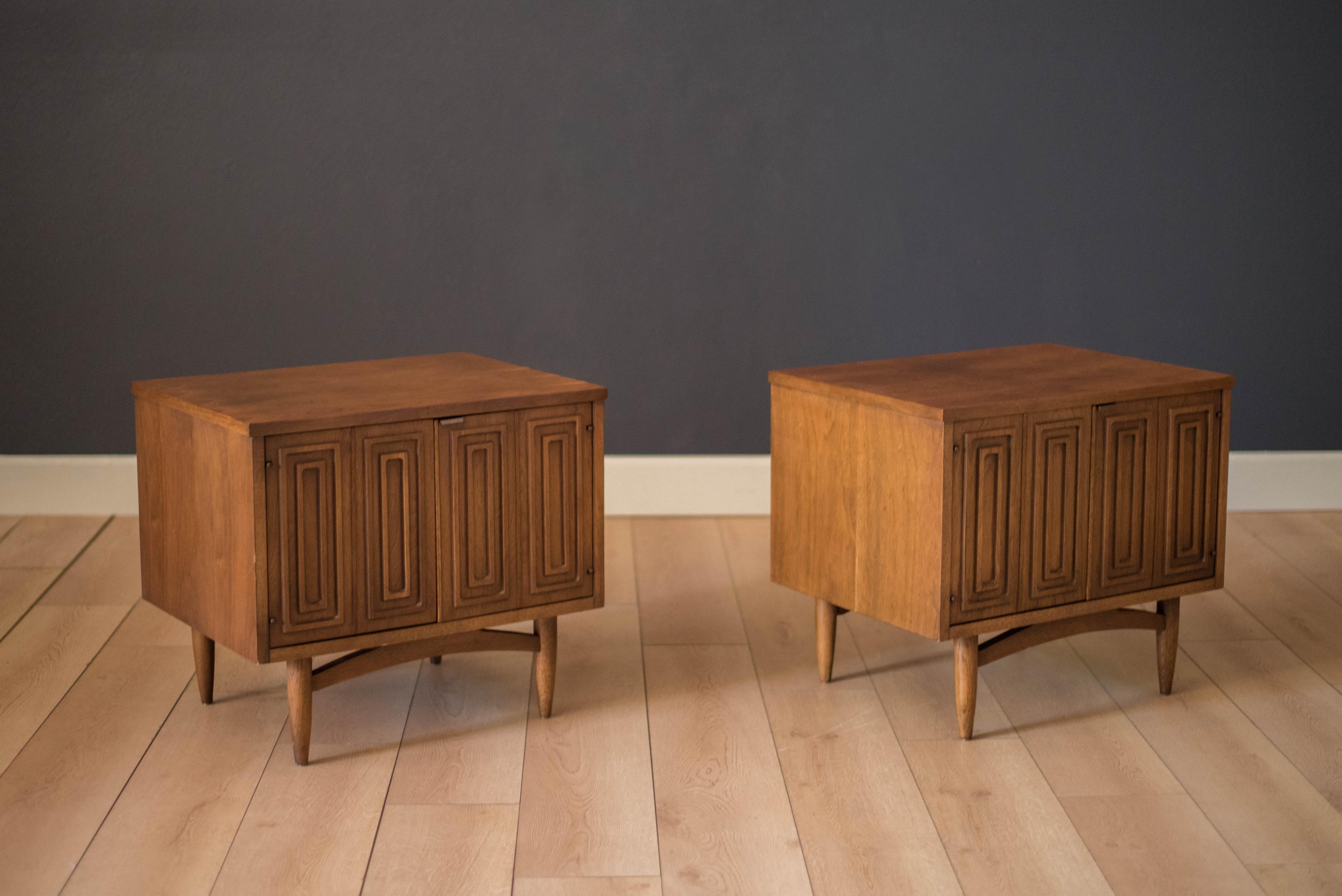 Vintage set of Sculptra nightstands or commodes by Broyhill in walnut and oak. Swing out doors reveal an open cabinet for plenty of storage. Alternatively, the set can be used as living room side or end tables. Price is for the pair. Matching