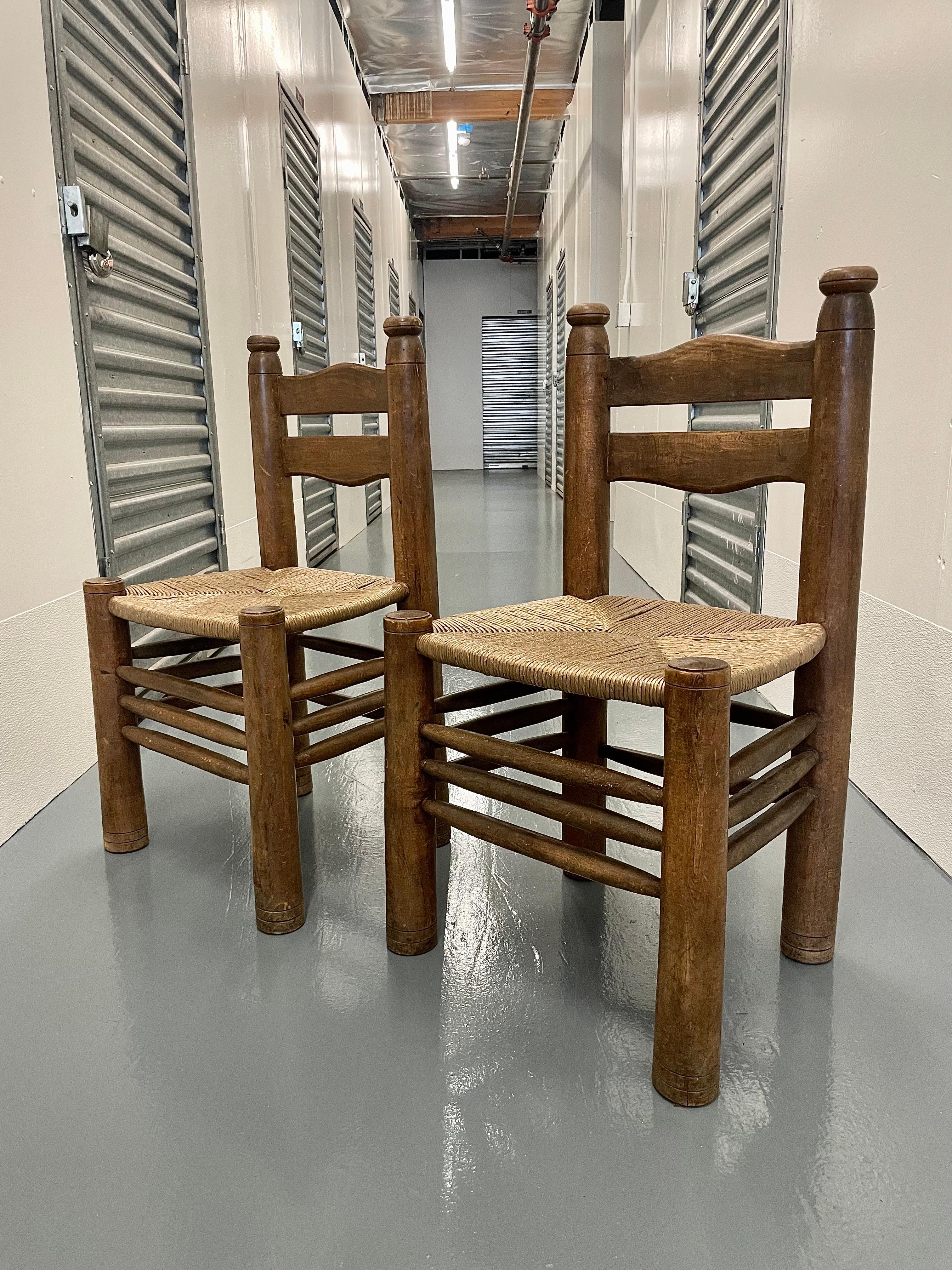Pair of Mid-Century Brutalist solid wood and rush chairs by Charles Dudouyt, 1940s.

Solid wood construction. Structurally sound for everyday use.

Over 80 years of patina.

Wear consistent with age and use.