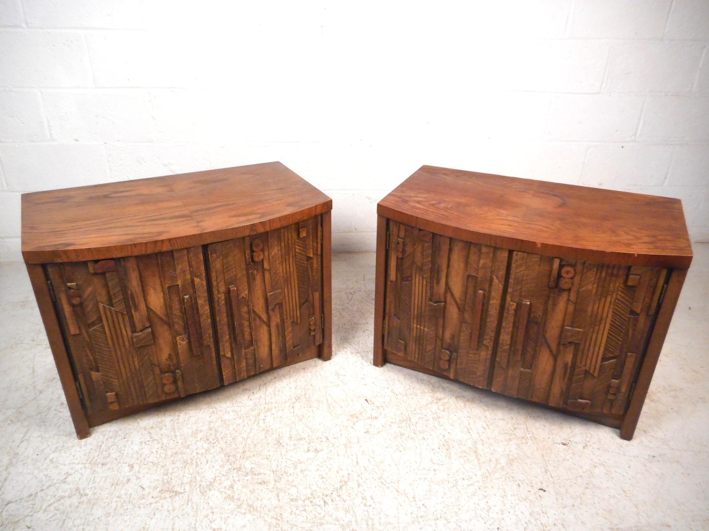 Stylish pair of mid-century nightstands / end tables with a brutalist-style decorative cabinet doors. Intricately designed and sturdy, these nightstands are sure to please when situated in any modern interior. Please confirm item location with