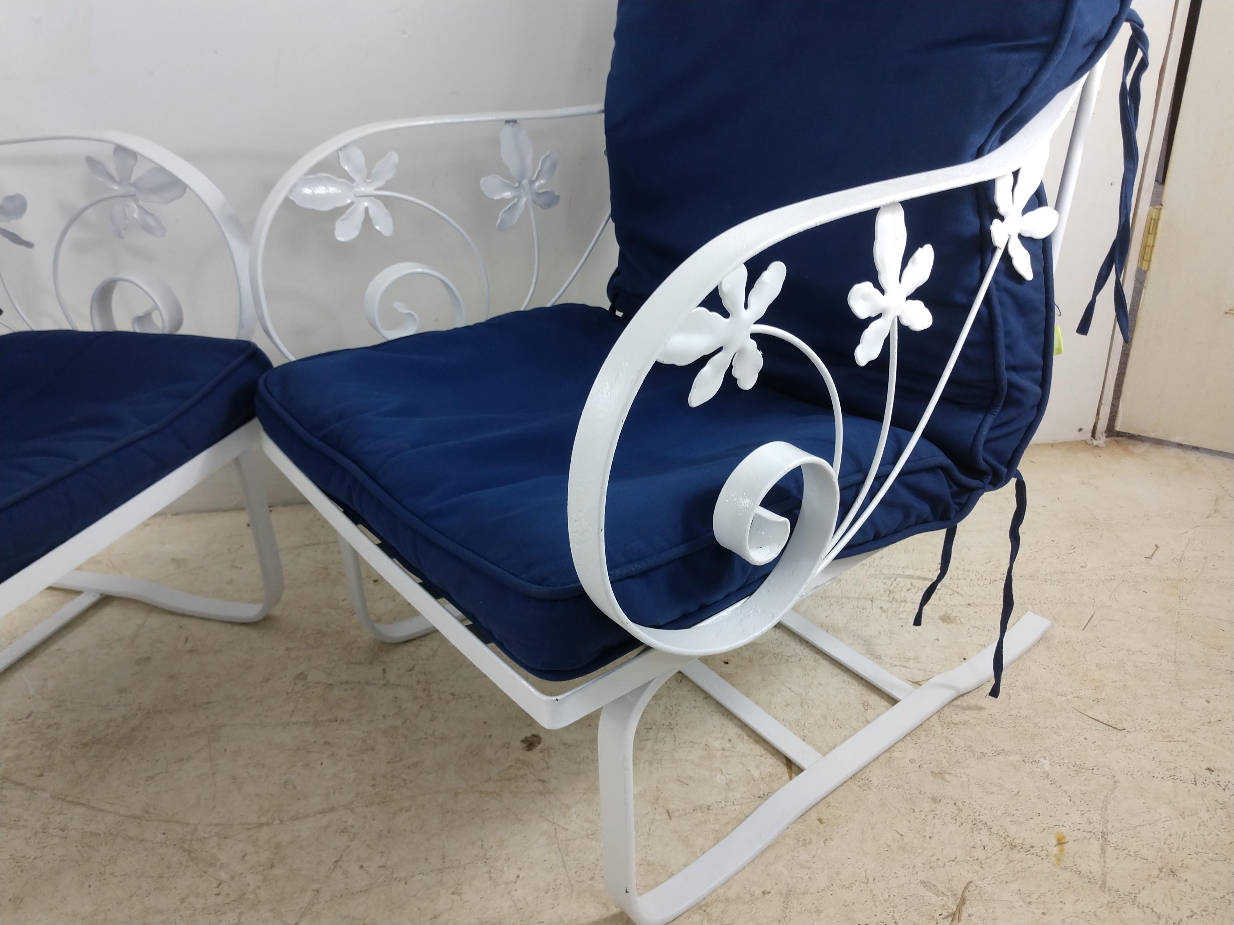 Fabulous pair of lounge rocker chairs by Woodard. Heavy duty gauge iron with a fresh coat of enamel. Seat hgt. is 15 Cushions are lightweight and included.