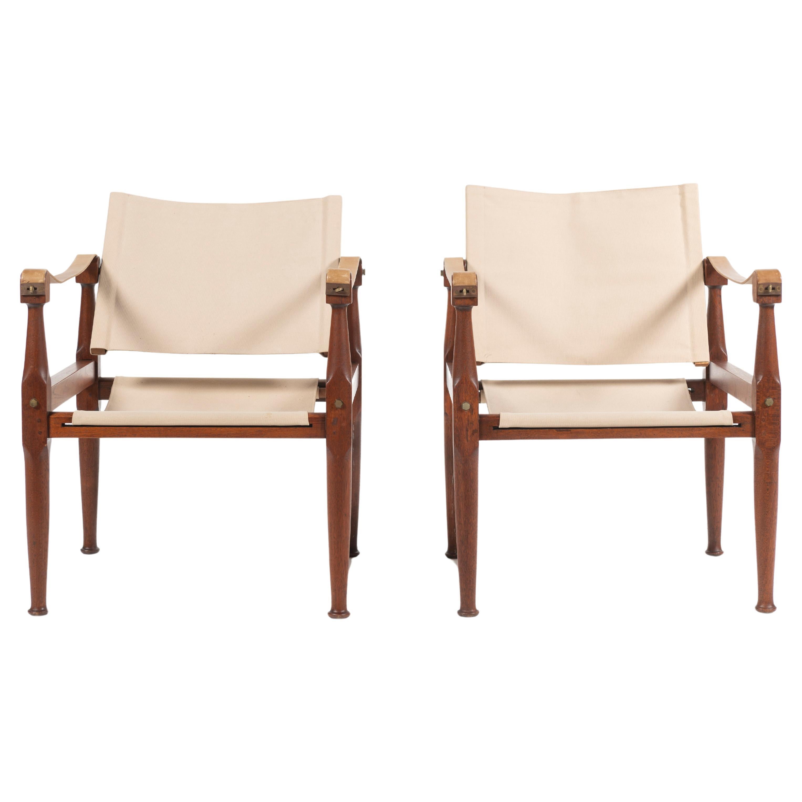 Wonderful pair of campaign chairs in teak, leather, canvas and brass inspired by Kaare Klint. Chairs are in good condition given their age and wear. Comfortable, casual and classic at once. Manufactured in Denmark, 1960. 
