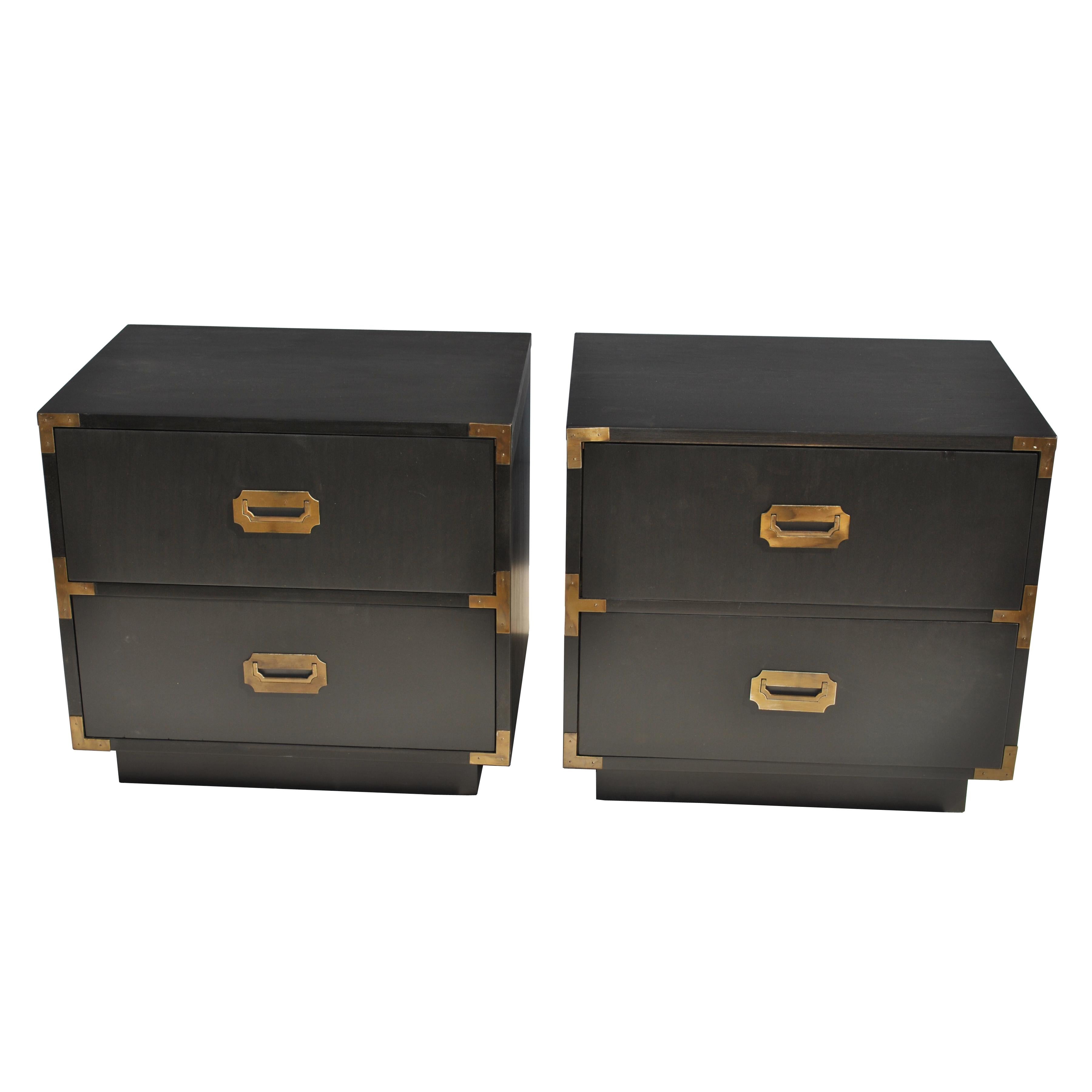 Pair of midcentury campaigner series nightstands by Dixie 

Pair of campaign-style nightstands with brass pulls and accents in an ebonized finish. 
Marked with the manufacturer. 

See 5-drawer dresser available.
