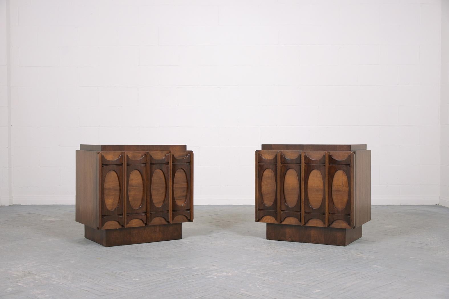 An extraordinary pair of vintage mid-century nightstands are in great condition, crafted out of walnut wood, and are newly restored by our professional craftsmen team. This set features an eye-catching two tones walnut color with lacquered finish,