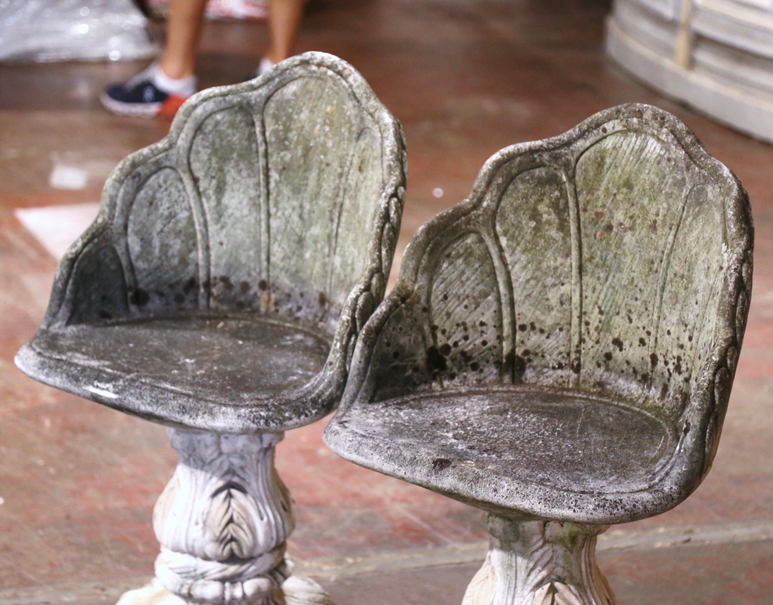 Decorate a patio or backyard with this vintage pair of garden chairs. Crafted in Italy circa 1950, each outdoor seating features a seat attached to a a sturdy column base decorated with foliage motifs in high relief. The concrete chairs have