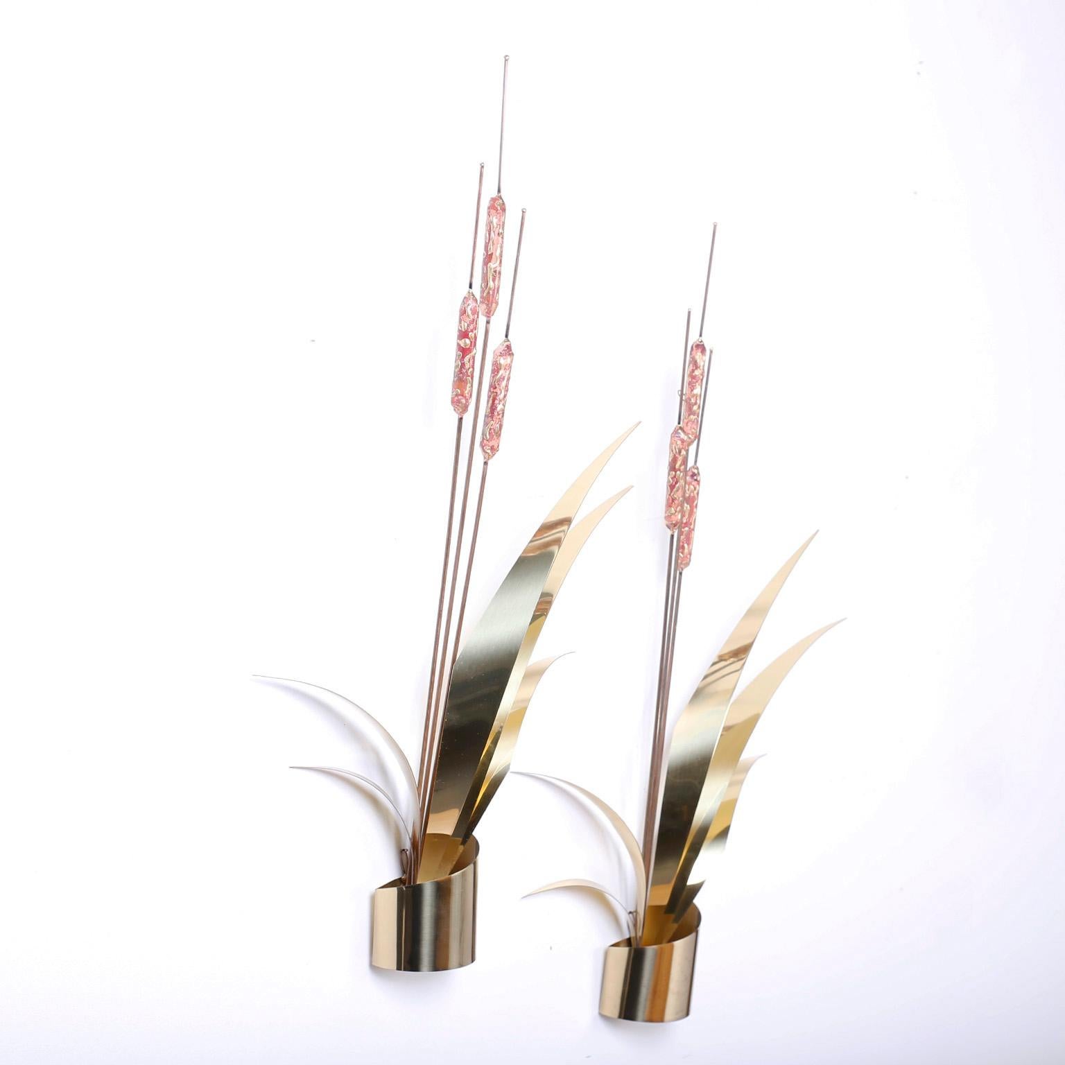 Swank pair of wall sculptures crafted in copper and brass in the form of stylized cattails or Typha. Hand polished and lacquered for easy care.
 