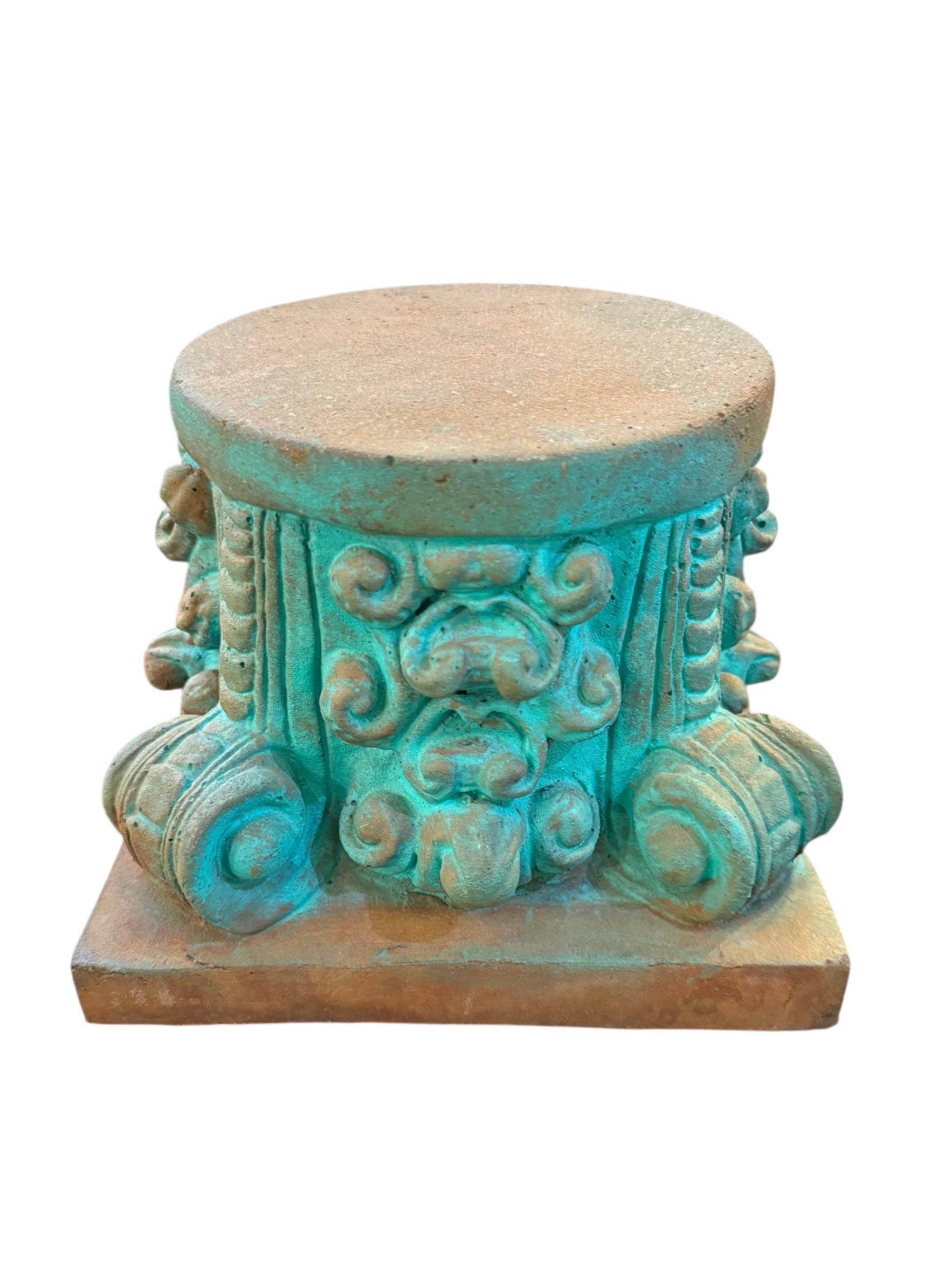 Bring a bold architectural statement to your space with this striking pair of Mid-Century cement pedestals. Featuring intricately sculpted scroll and volute motifs inspired by classical column capitals, these heavy, durable bases showcase a vibrant