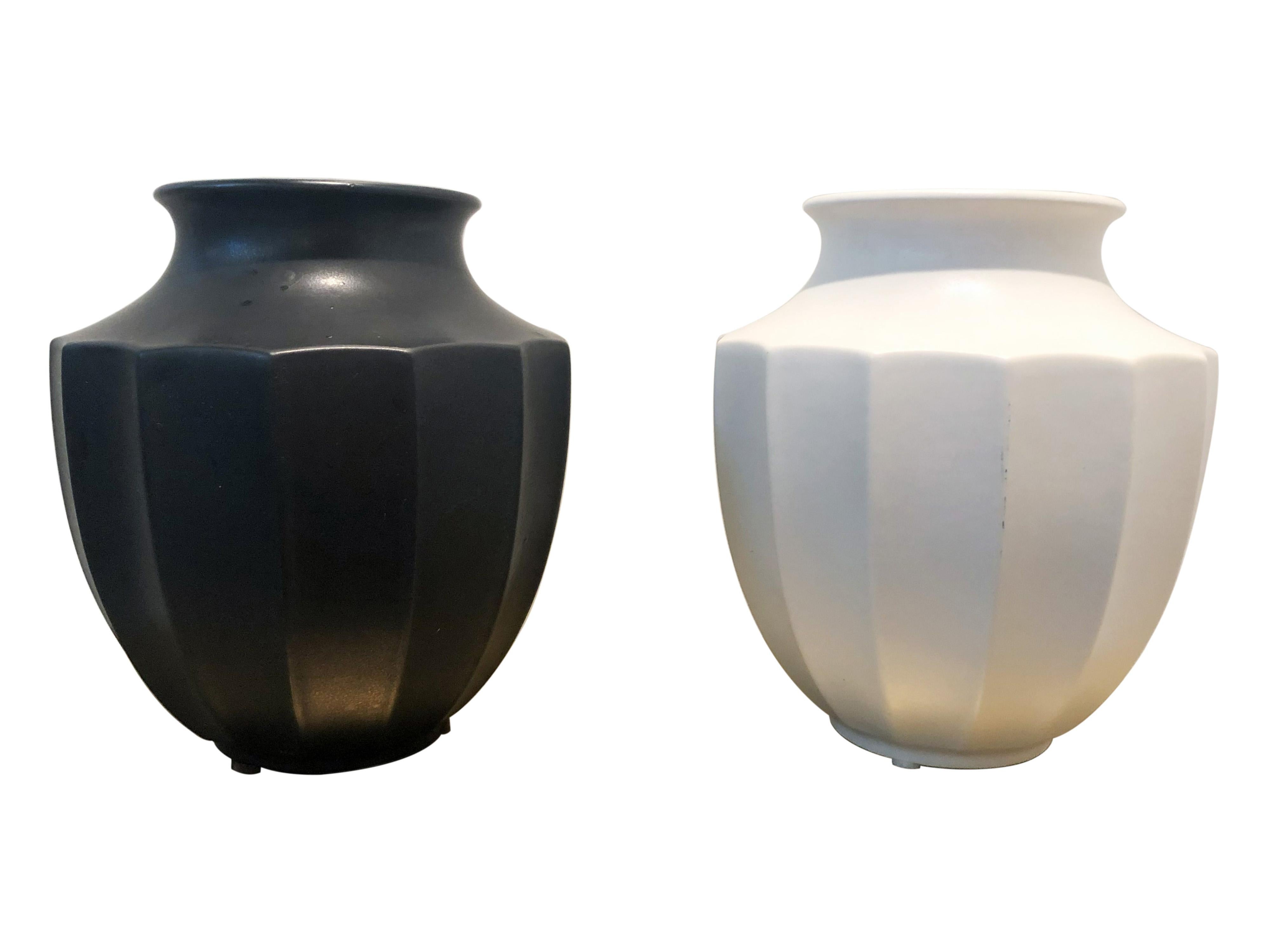Pair of American midcentury ceramic black and white vases/urns with ridged sides and a matte finish. Top is 4.25