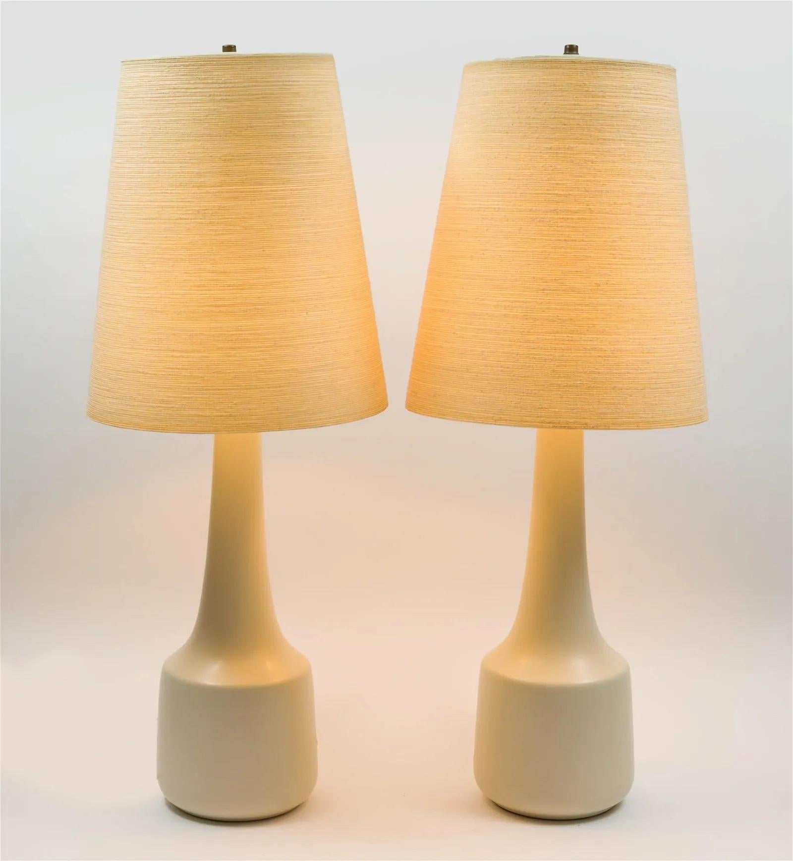 Pair of midcentury ceramic table lamps by Lotte and Gunnar Bostlund, with original jute lampshades. Circa 1970s. Canada.

Height: 36 in (86.36 cm) diameter: 7 ½ in (17.78 cm)

Shades : 16 in H x 14 in W.