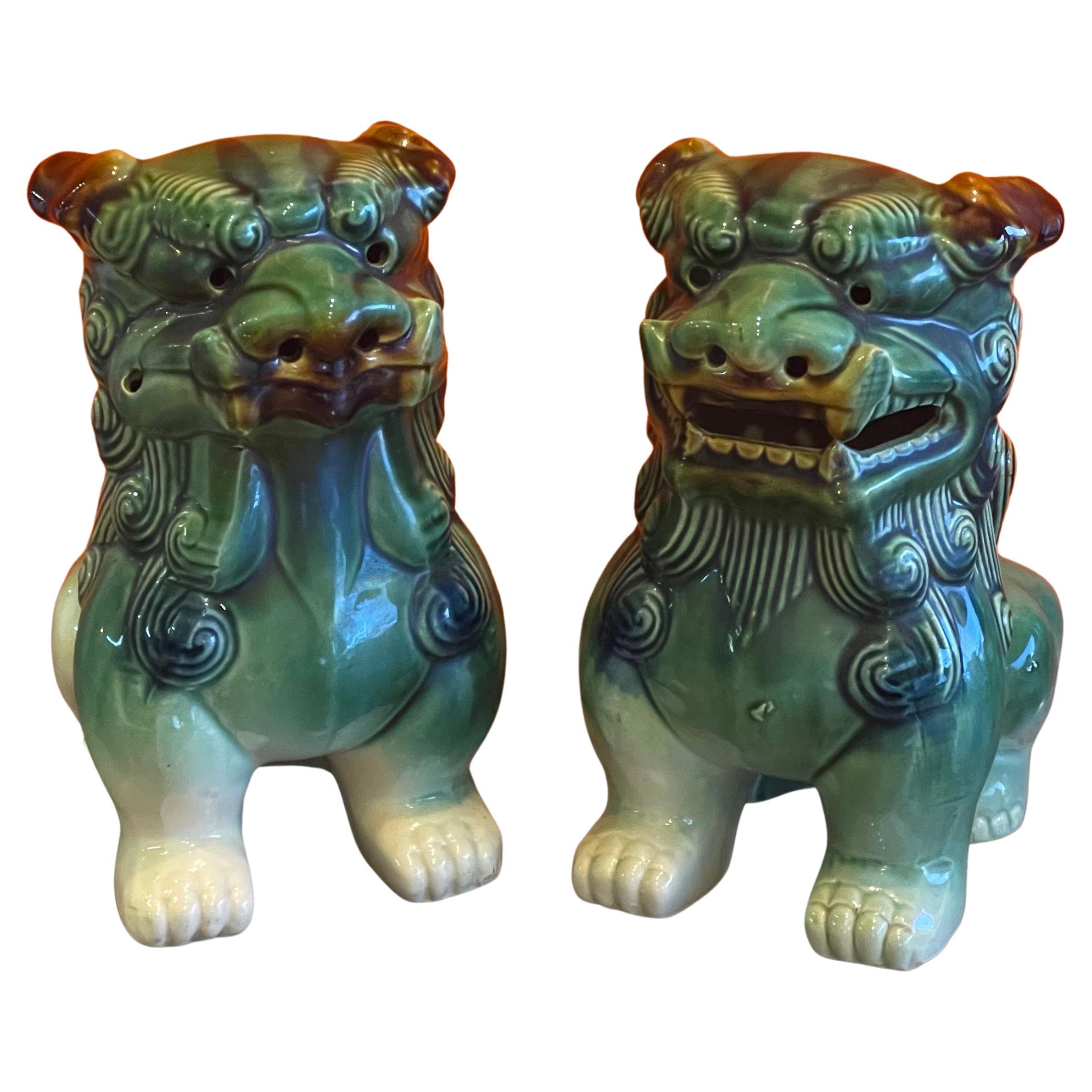 Großartiges Paar polychrom glasierter Keramikhunde aus der Mitte des Jahrhunderts, ca. 1960er Jahre. Tolle Details und eine schöne Farbkombination aus Grün, Braun, Creme und Blau; das Paar misst 12